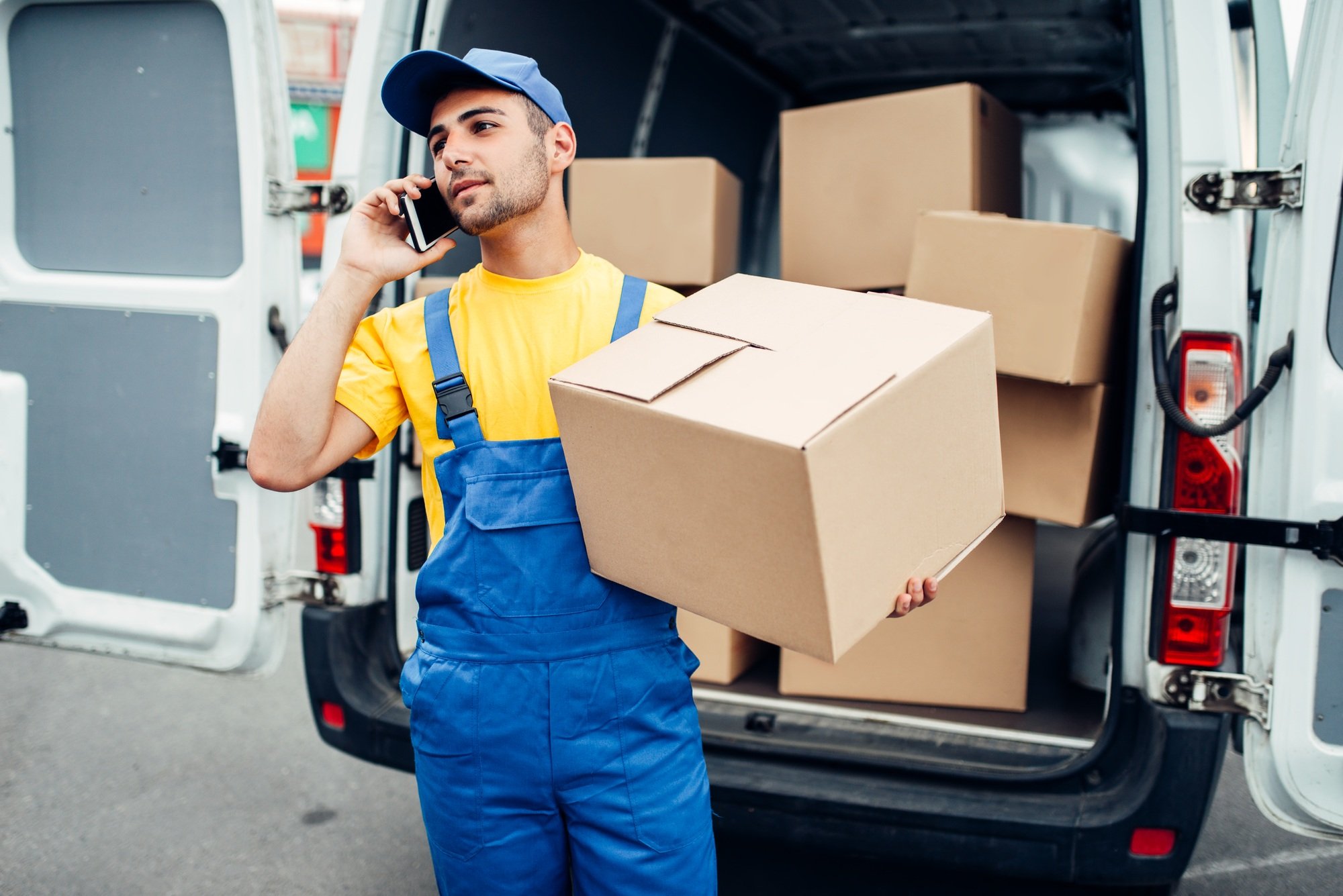 Cargo delivery service, courier with box and phone