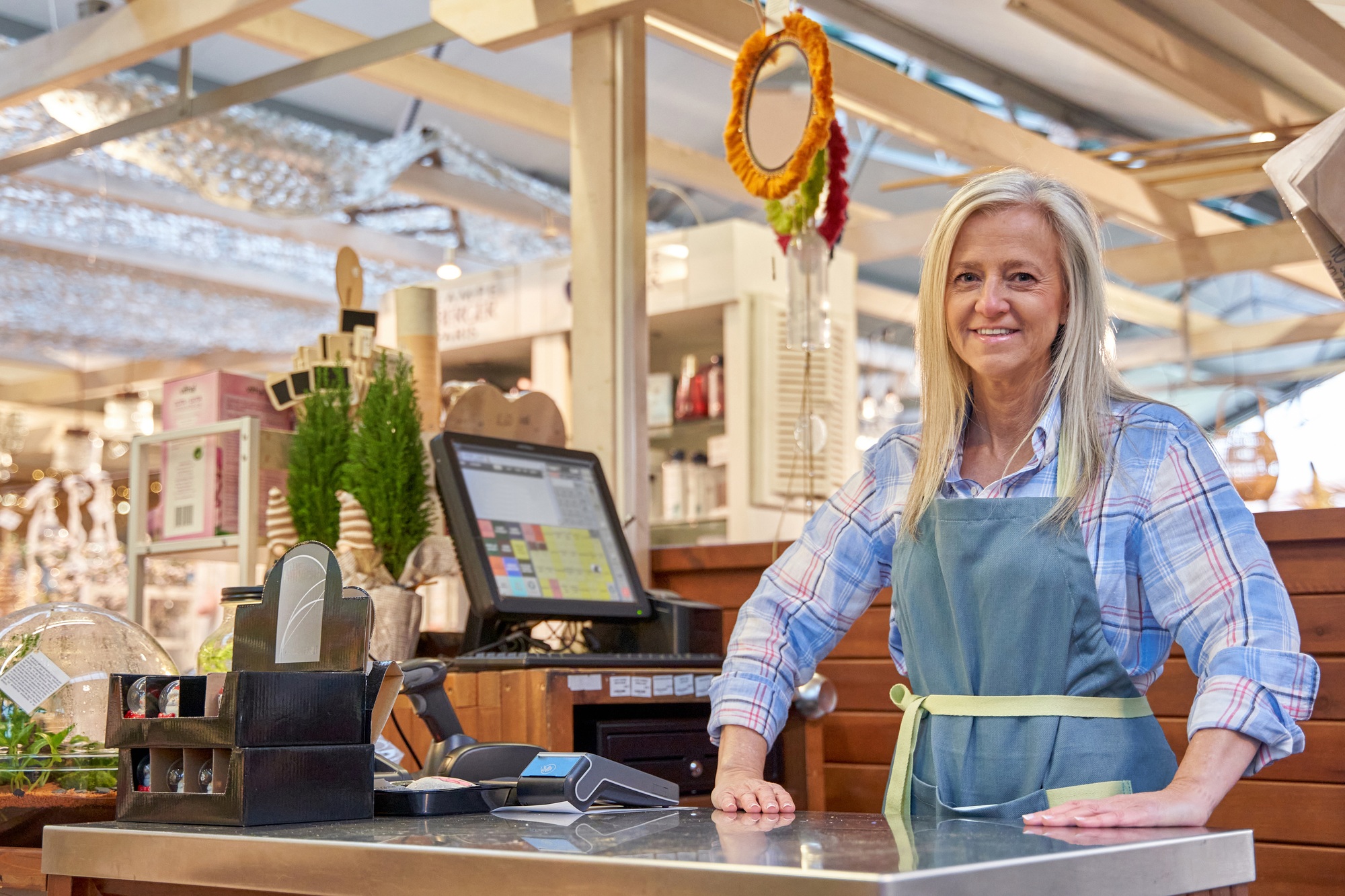 cashier at her workstation looking at the camera