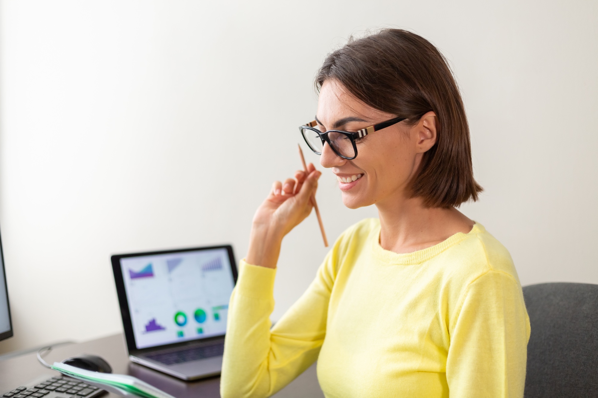 Caucasian advisor financial business analytics woman with data dashboard graphs smiles happy mood