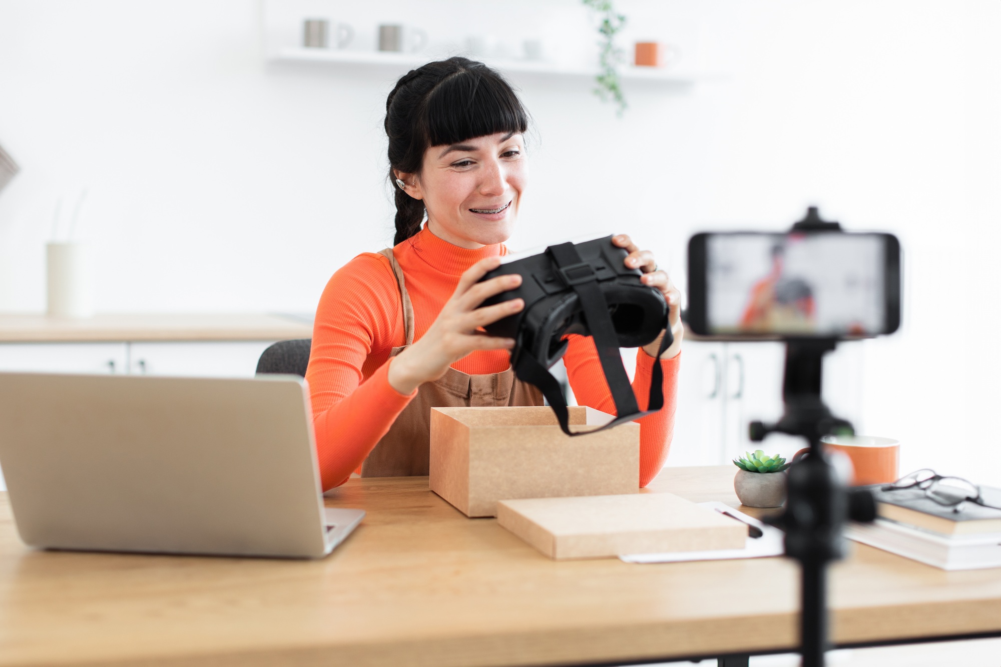 Caucasian female blogger unboxing new virtual reality headset online