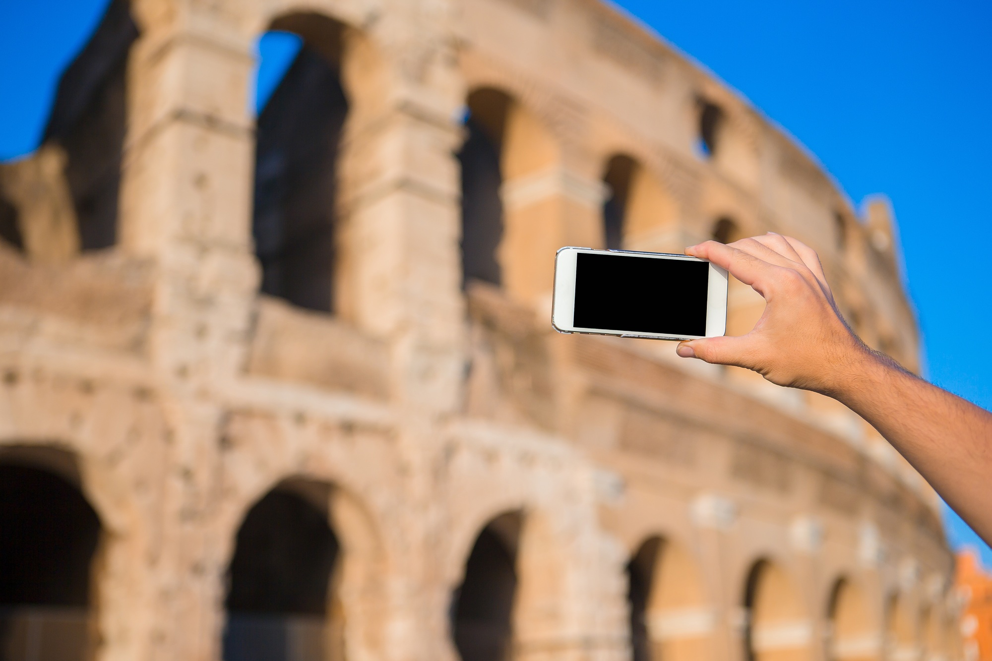 Closeup smart phone take the photo of Colosseum in Rome, Italy