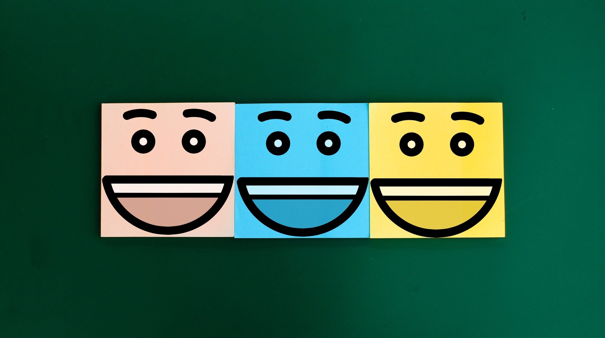 colored paper with three happy faces. Business service rating concept.