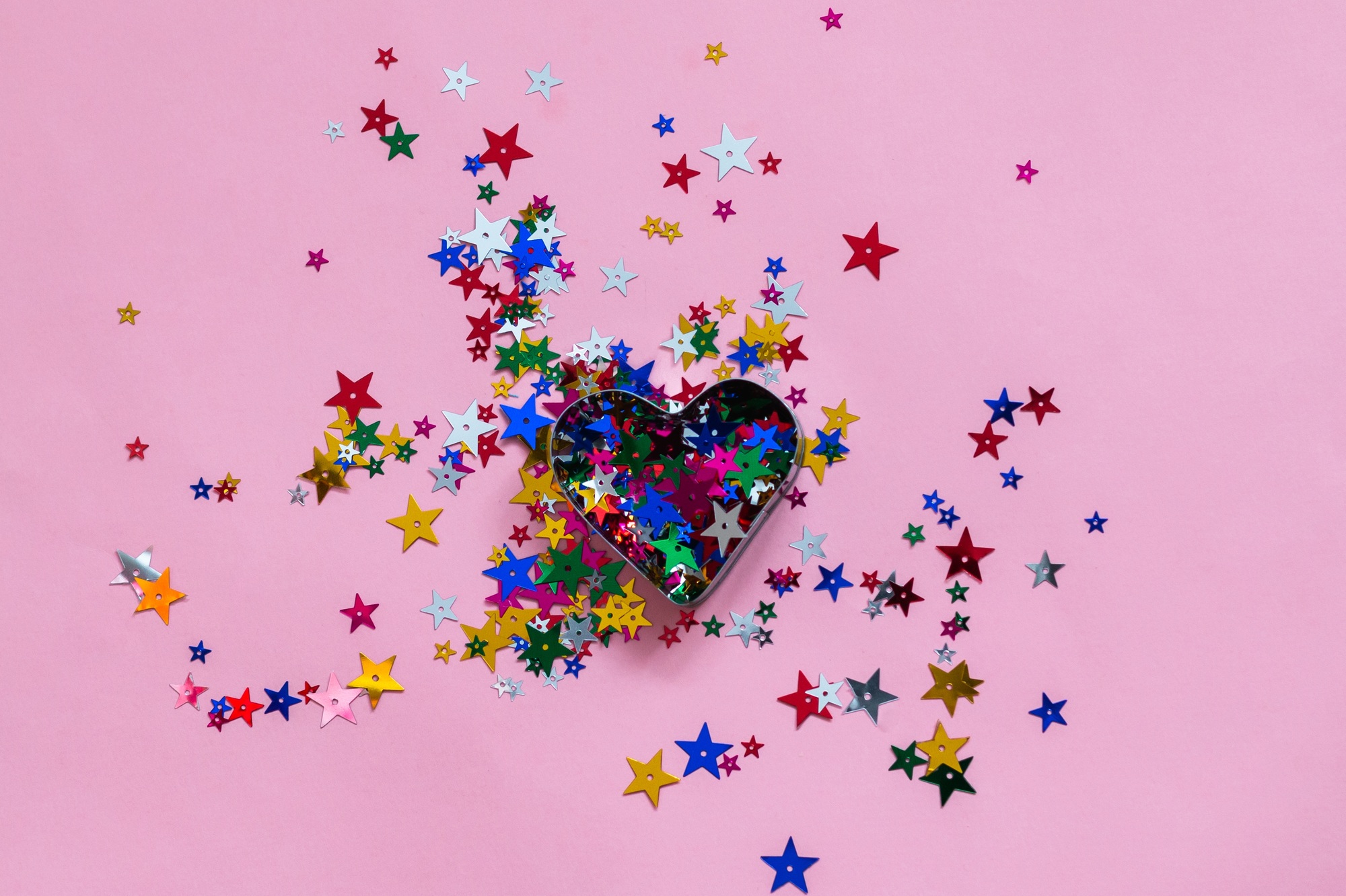 colored sparkles on pink background, Valentine's Day or birthday greeting card template