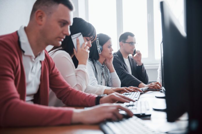 Communication with customers. Young people working in the call center. New deals is coming