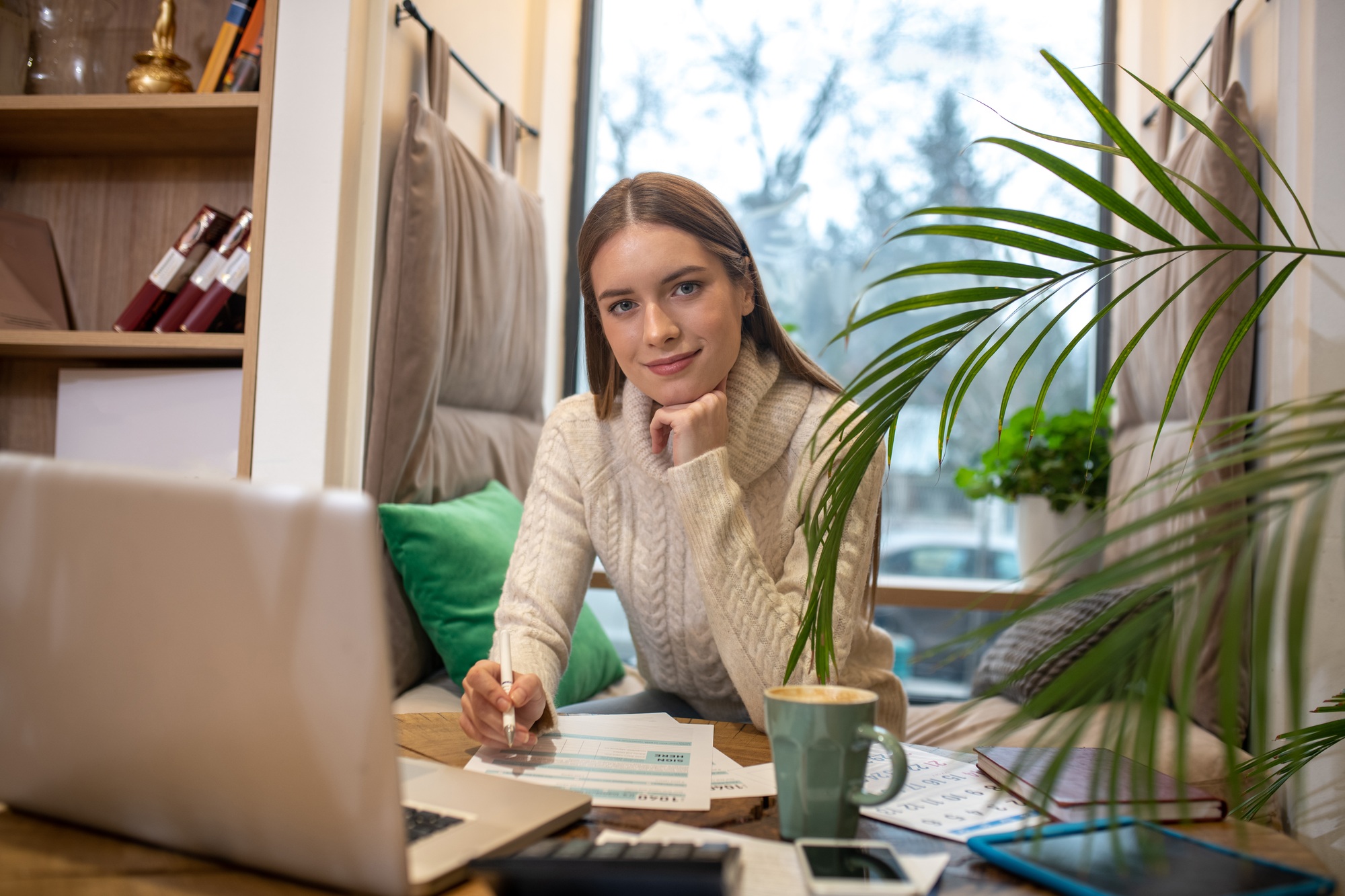 Confident young woman doing accounting for her business