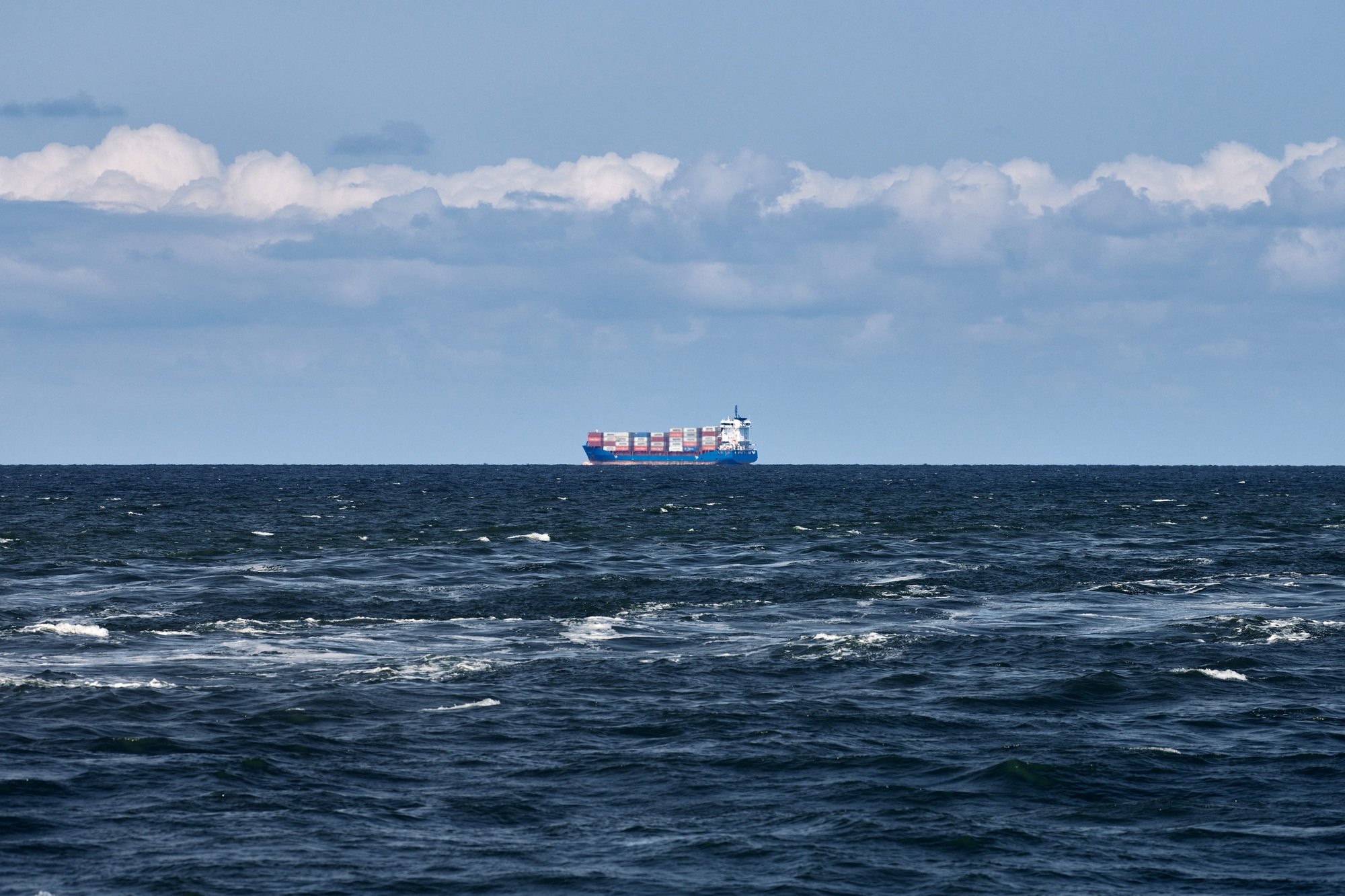 Container cargo ship freighter, import export trade logistic transportation, cargo ship in blue sea