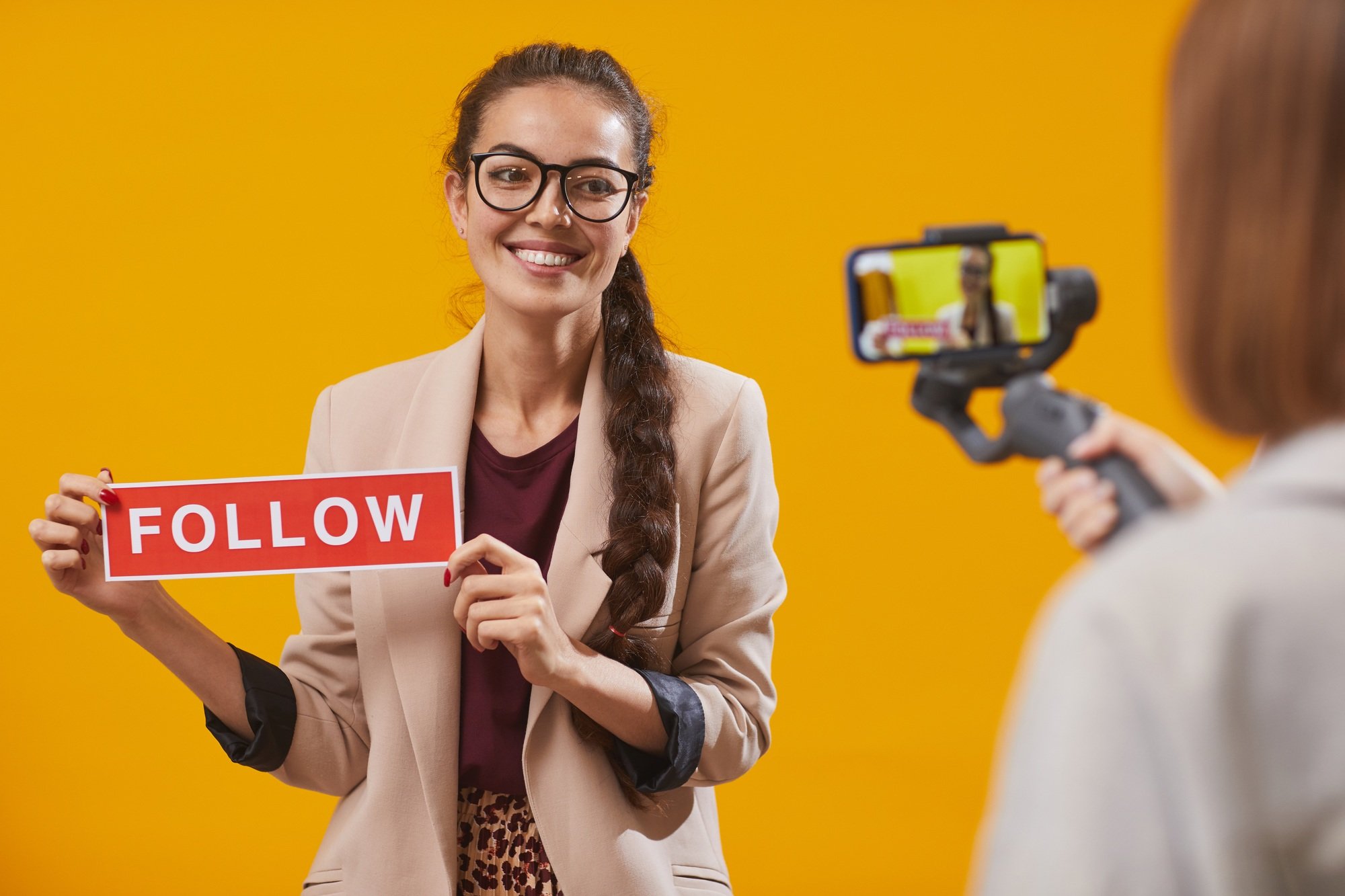 Contemporary Young Woman Holding Follow Word