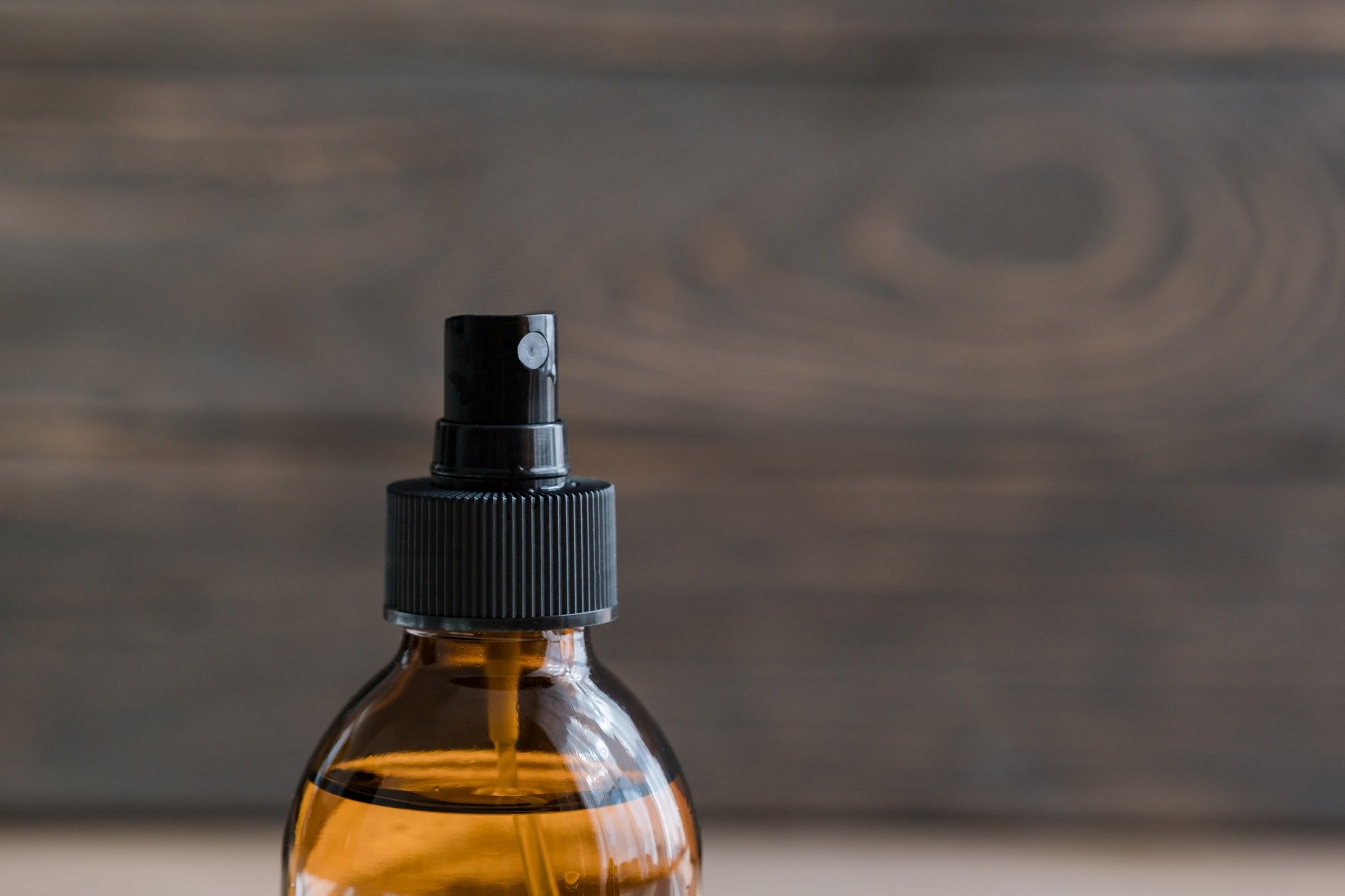 Cosmetic brown glass mist bottle. Closeup, minimalism concept. Brand packaging layout. Copy space