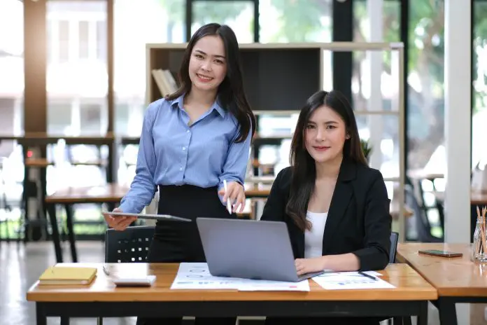 Creative young Asian business woman meeting to plan events. Take note of the job description