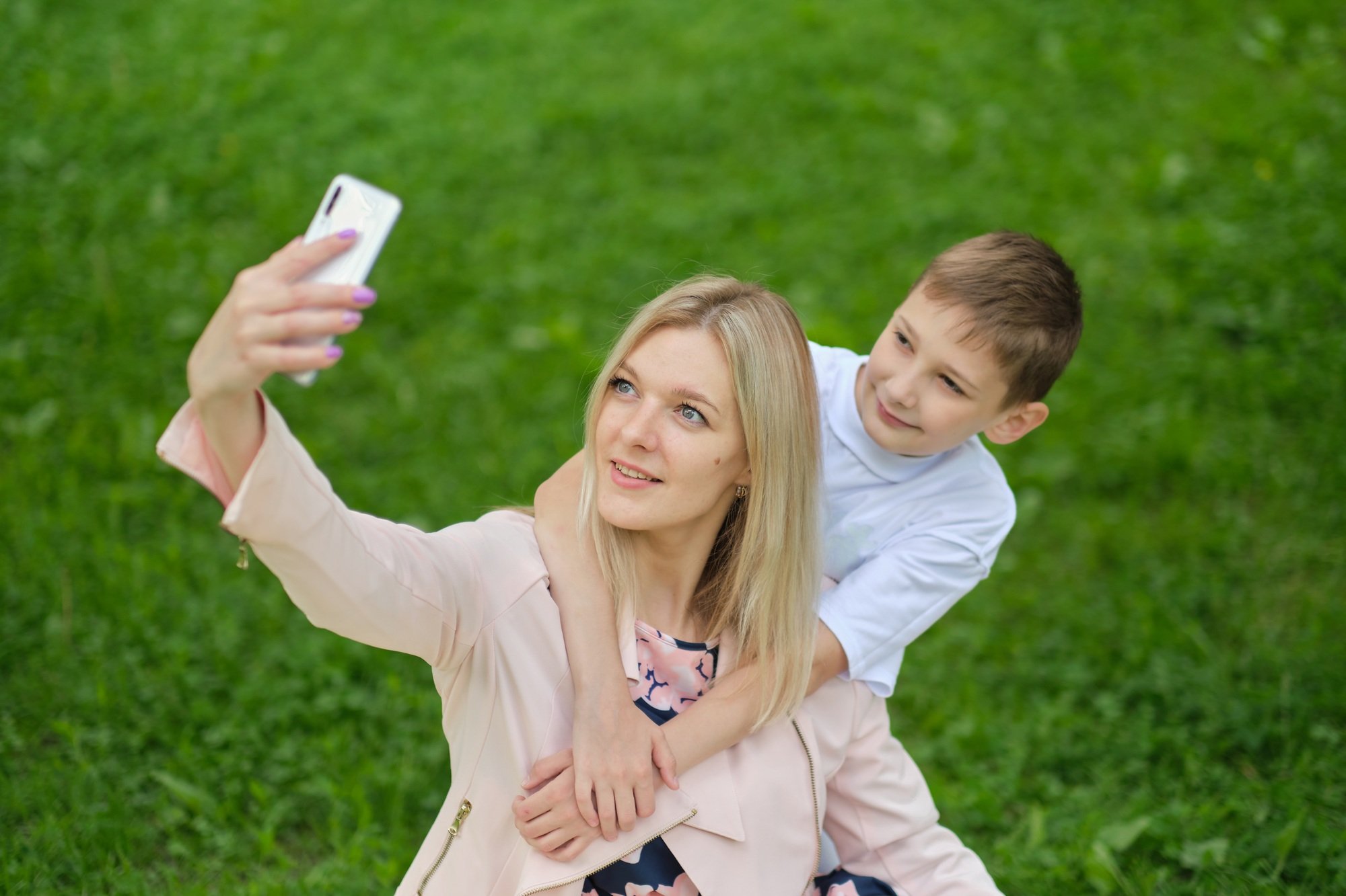 Digital memories: A mother and her teenage boy happily document their time together with a