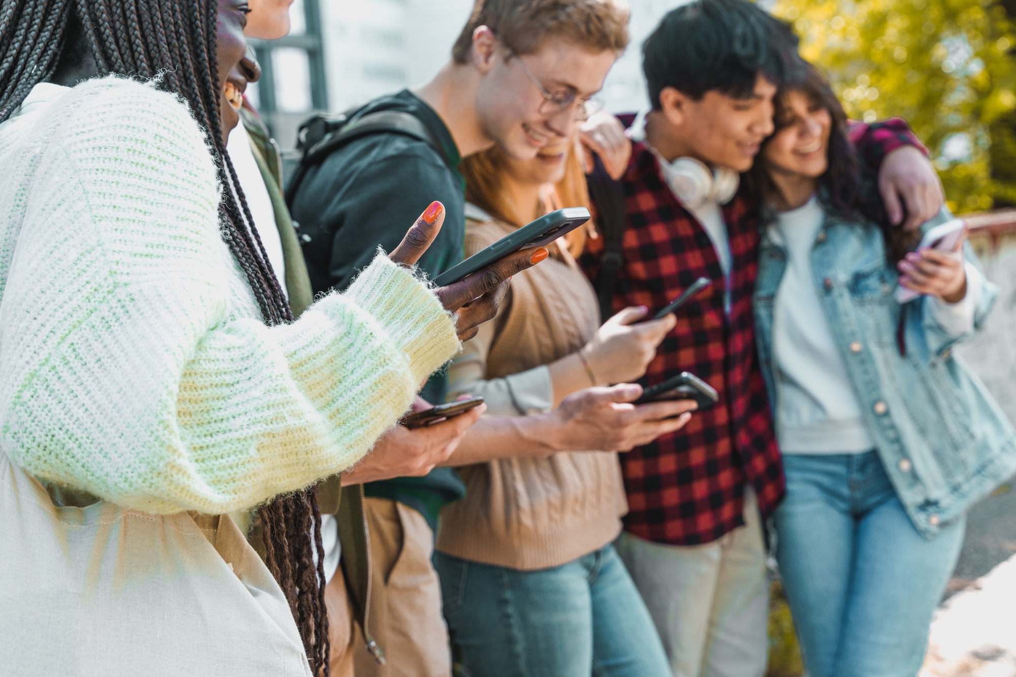 Diverse Friends Sharing Content on Smartphones