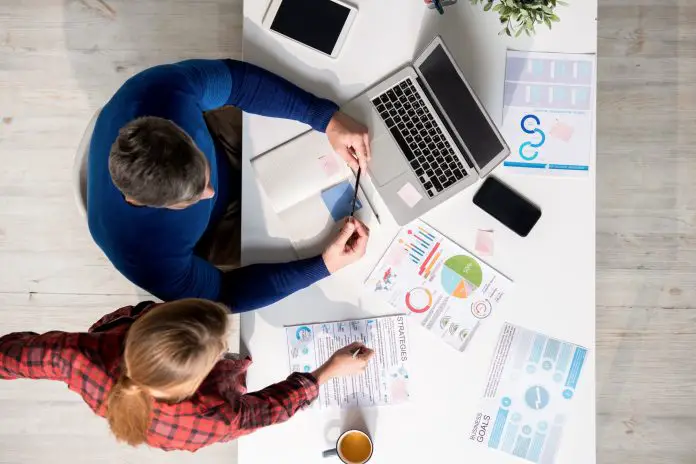 Employees analyzing strategies while thinking about approach