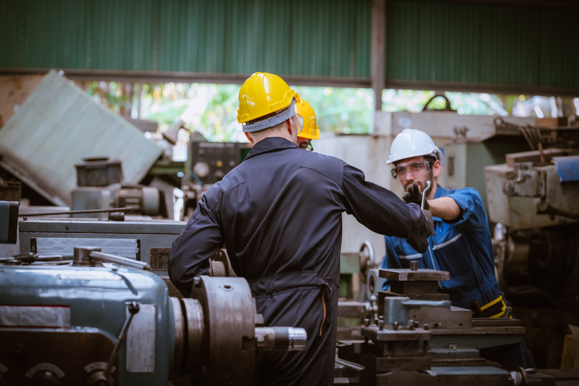Engineer worker wearing safety uniform control operating computer controlled Lathe grinding machine