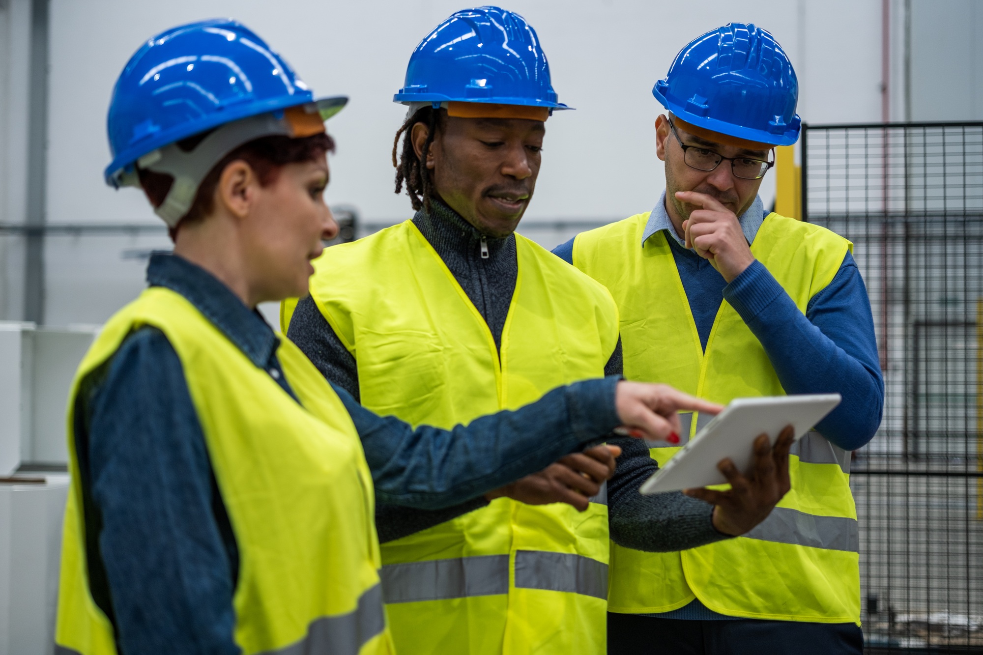 Engineers reviewing data on the tablet of the tests carried out in the factory