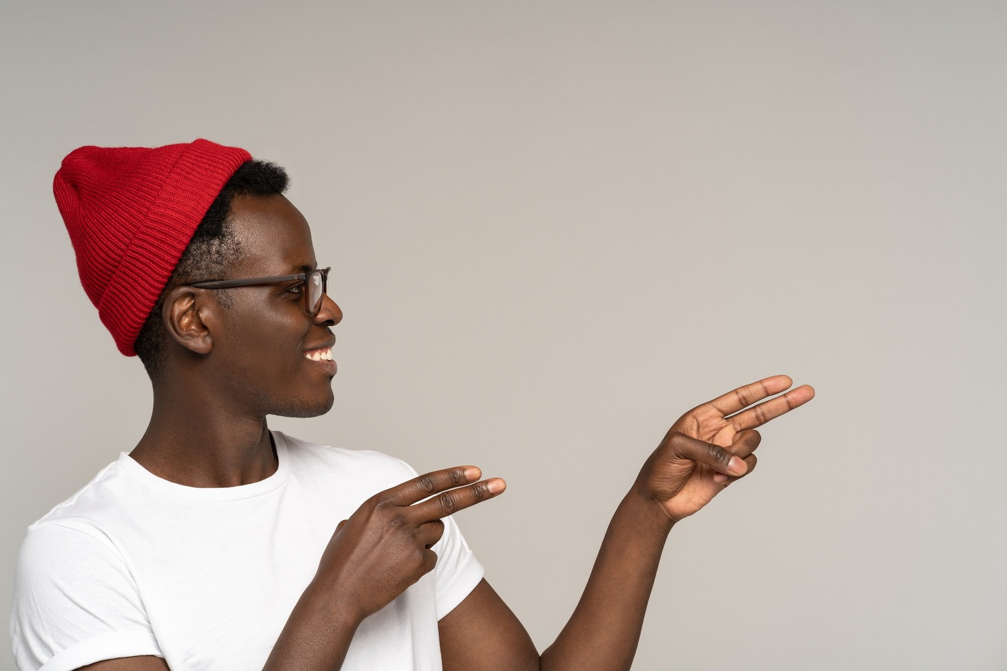 Excited african man look and point finger to copy space for text ads, business offer or promotion
