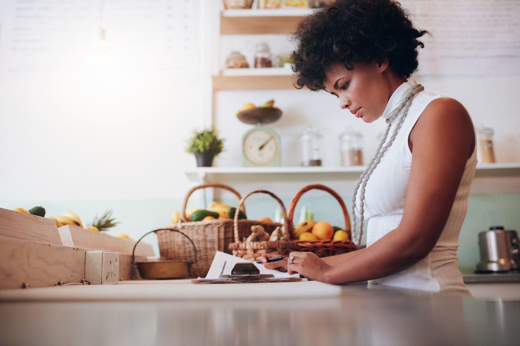 Female juice bar owner doing account