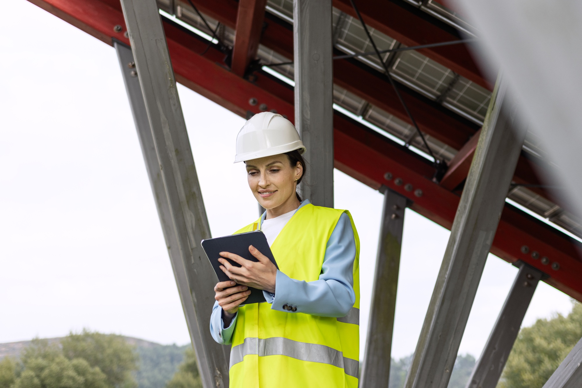 Female Solar energy engineer working outdoor on ecological solar farm construction