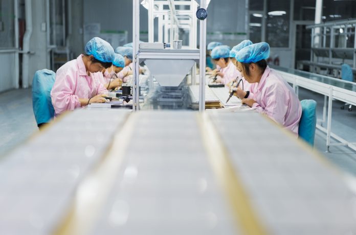 Female workers in solar panel assembly factory, Solar Valley, Dezhou, China