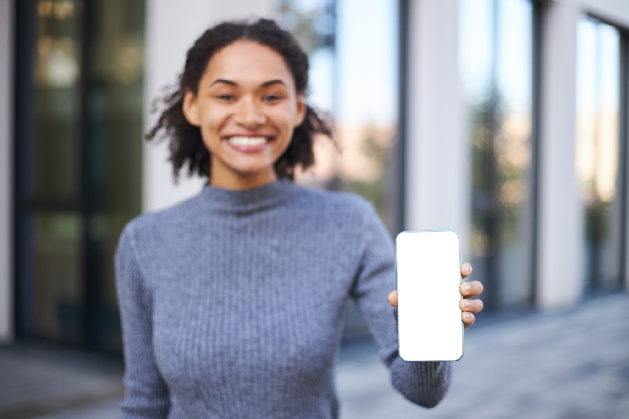 Focus on a modern smartphone with white blank screen with free space for your ads or mobile apps