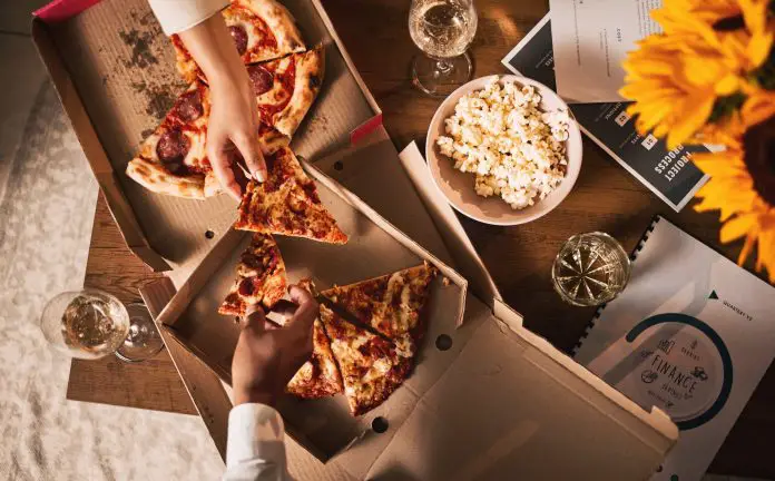 Food, pizza and hands, business meeting and wine with paperwork, people in team and dinner with top