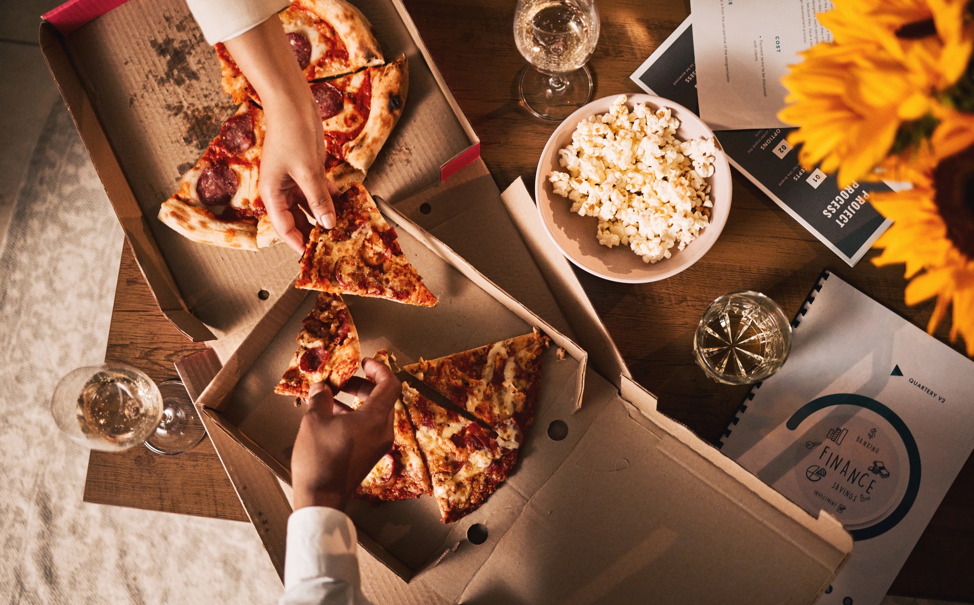 Food, pizza and hands, business meeting and wine with paperwork, people in team and dinner with top