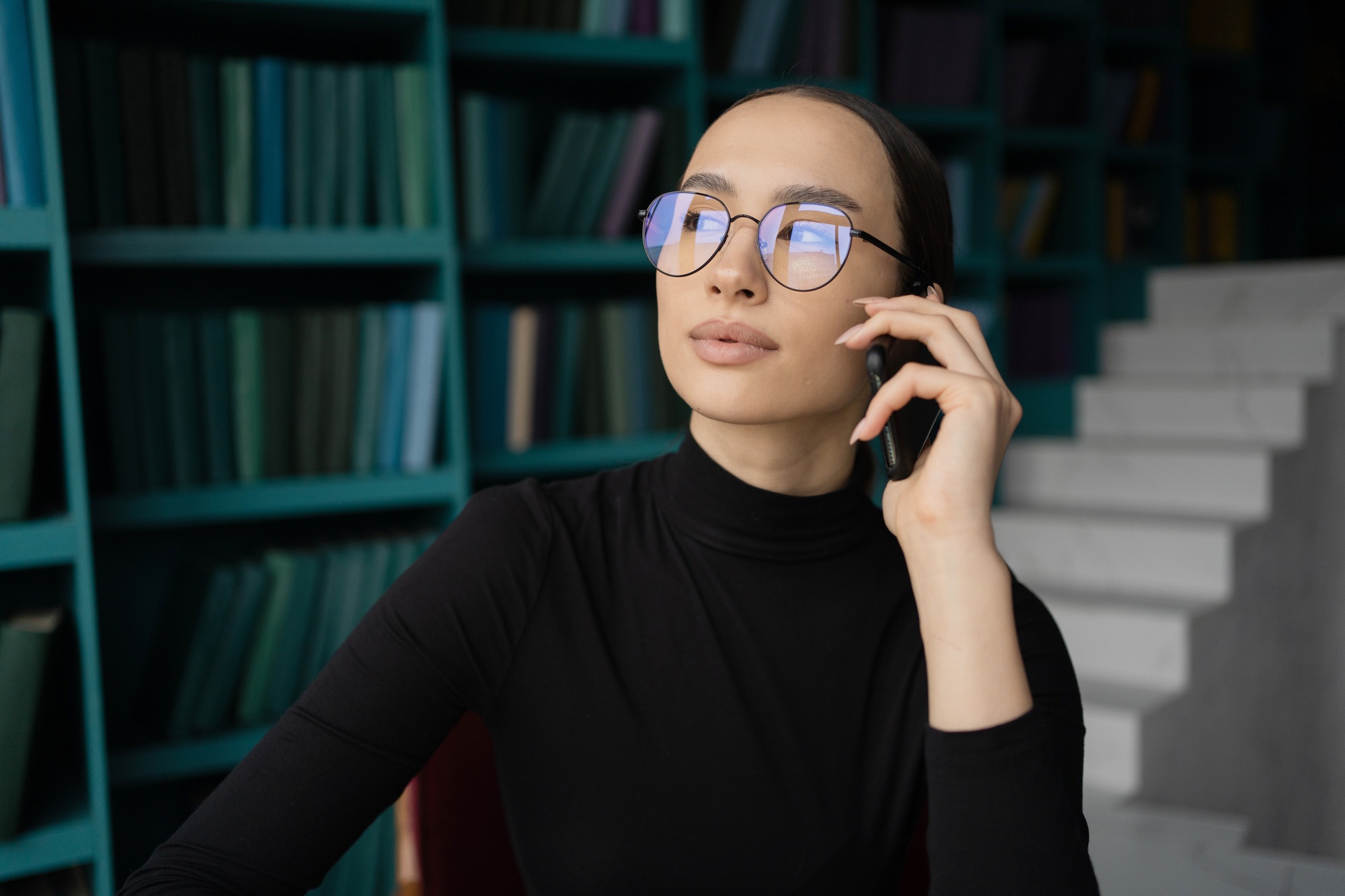 freelancer woman with glasses working in an office, workplace coworking space