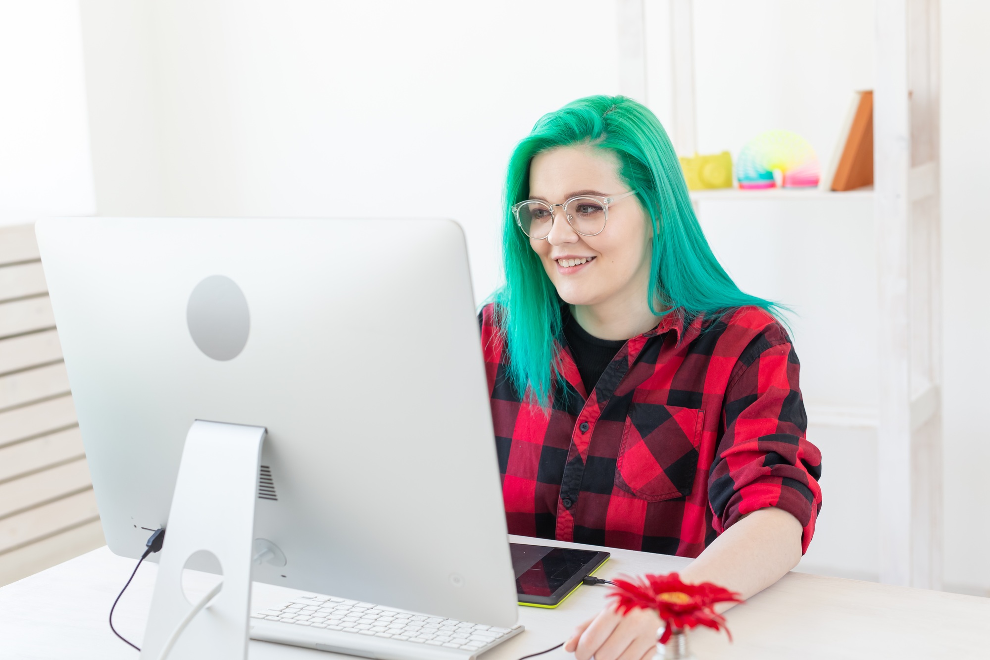 Graphic designer, animator and illustrator concept - young woman with green hair working at the
