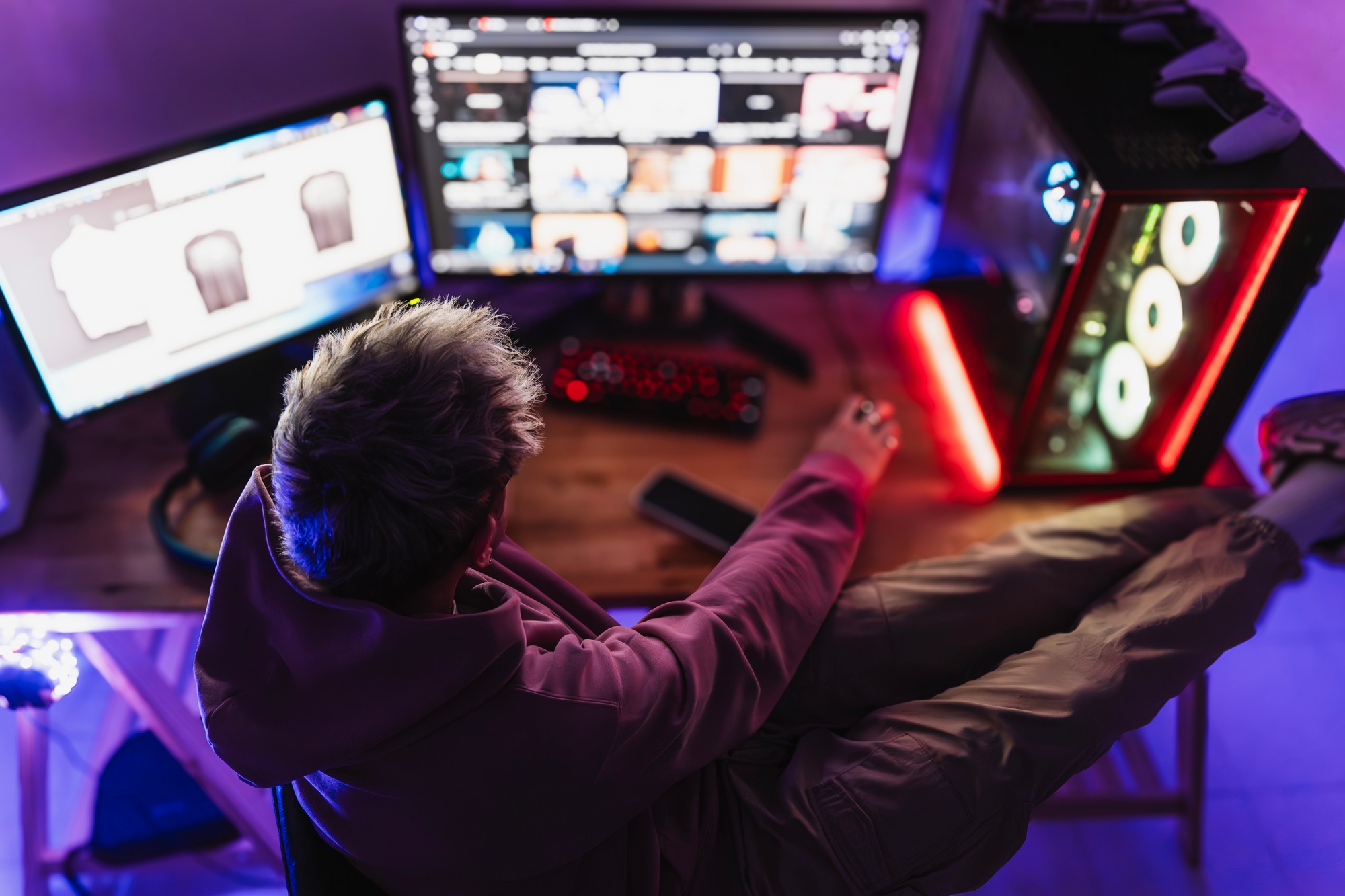 Graphic designer working comfortably on the setup of his room