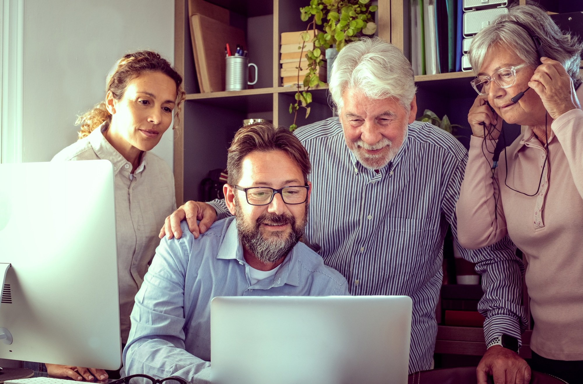 Group of business people working and communicating looking at online e-commerce development project