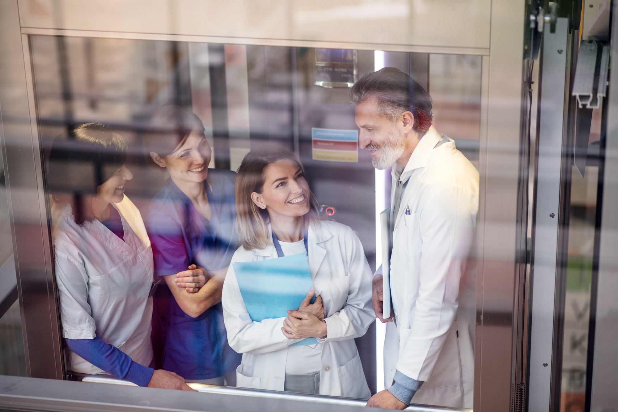 Group of doctors in elevator on medical conference, talking