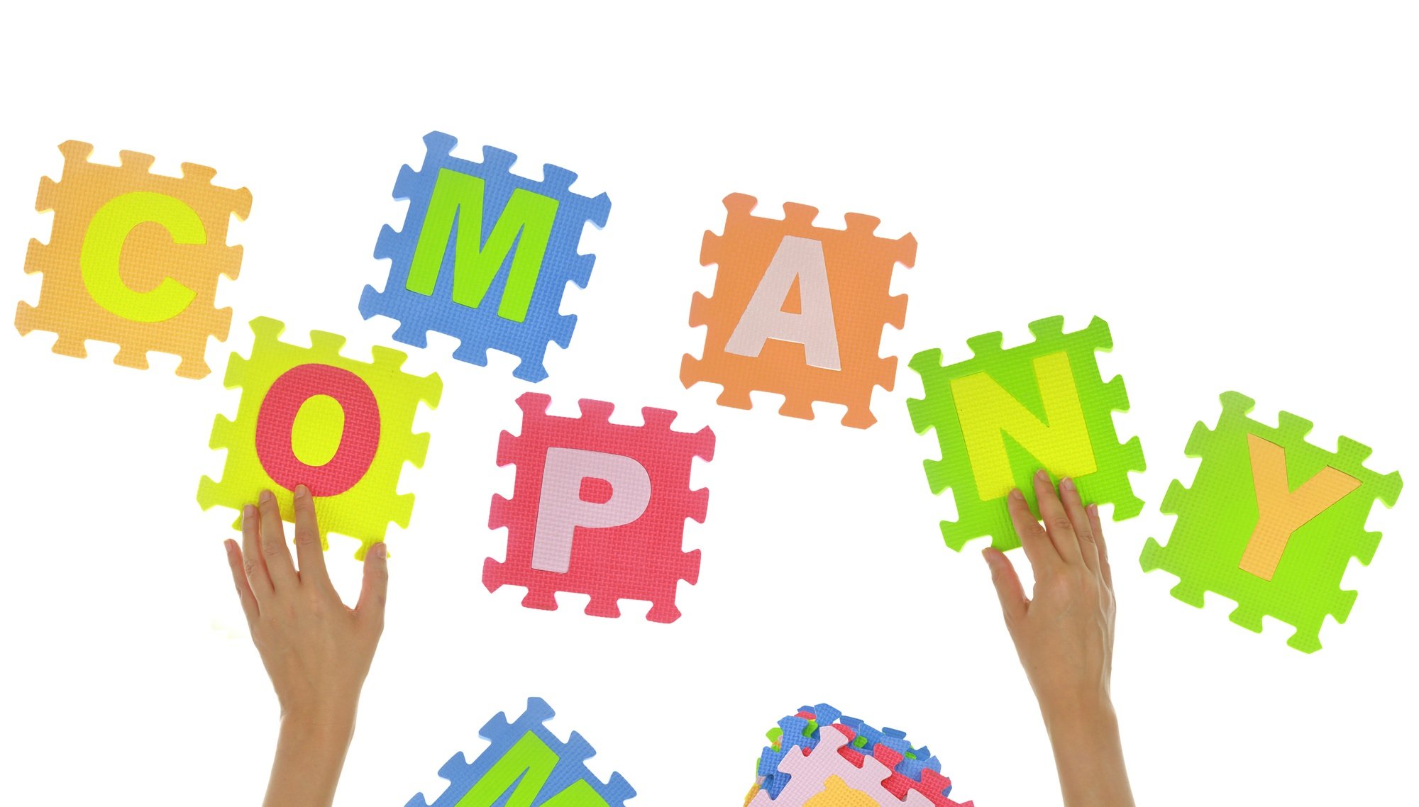 Hands forming word "Company" with jigsaw puzzle pieces isolated
