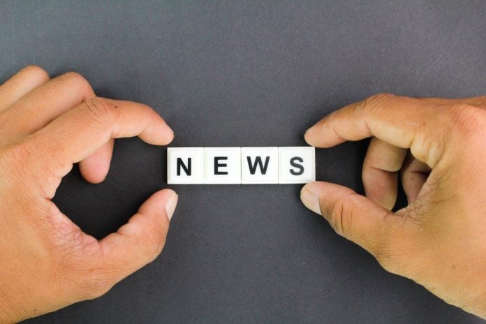 hands holding letters of the alphabet with the word news