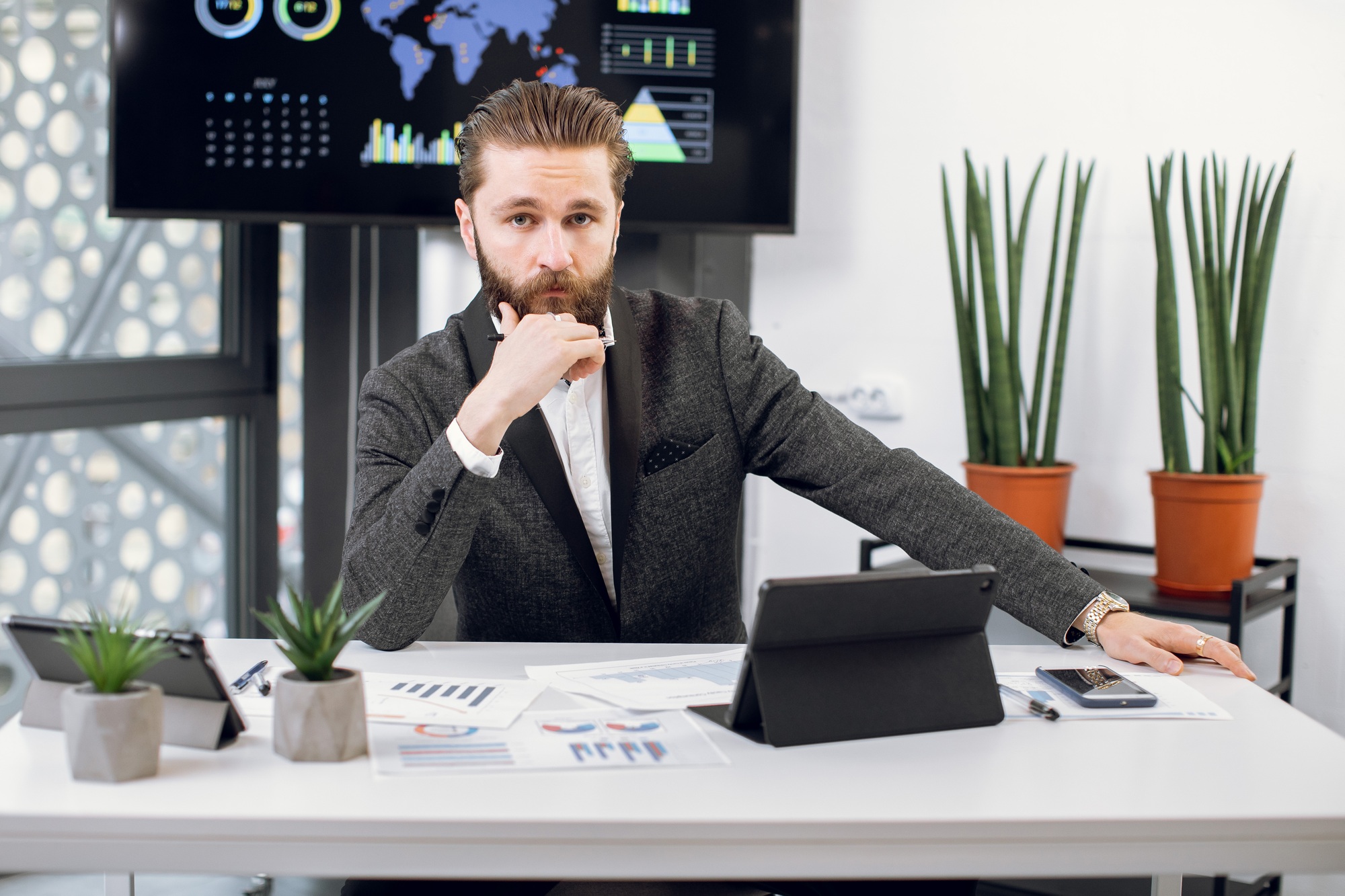 Handsome purposeful confident bearded businessman, chief executive officer in formal wear, sitting