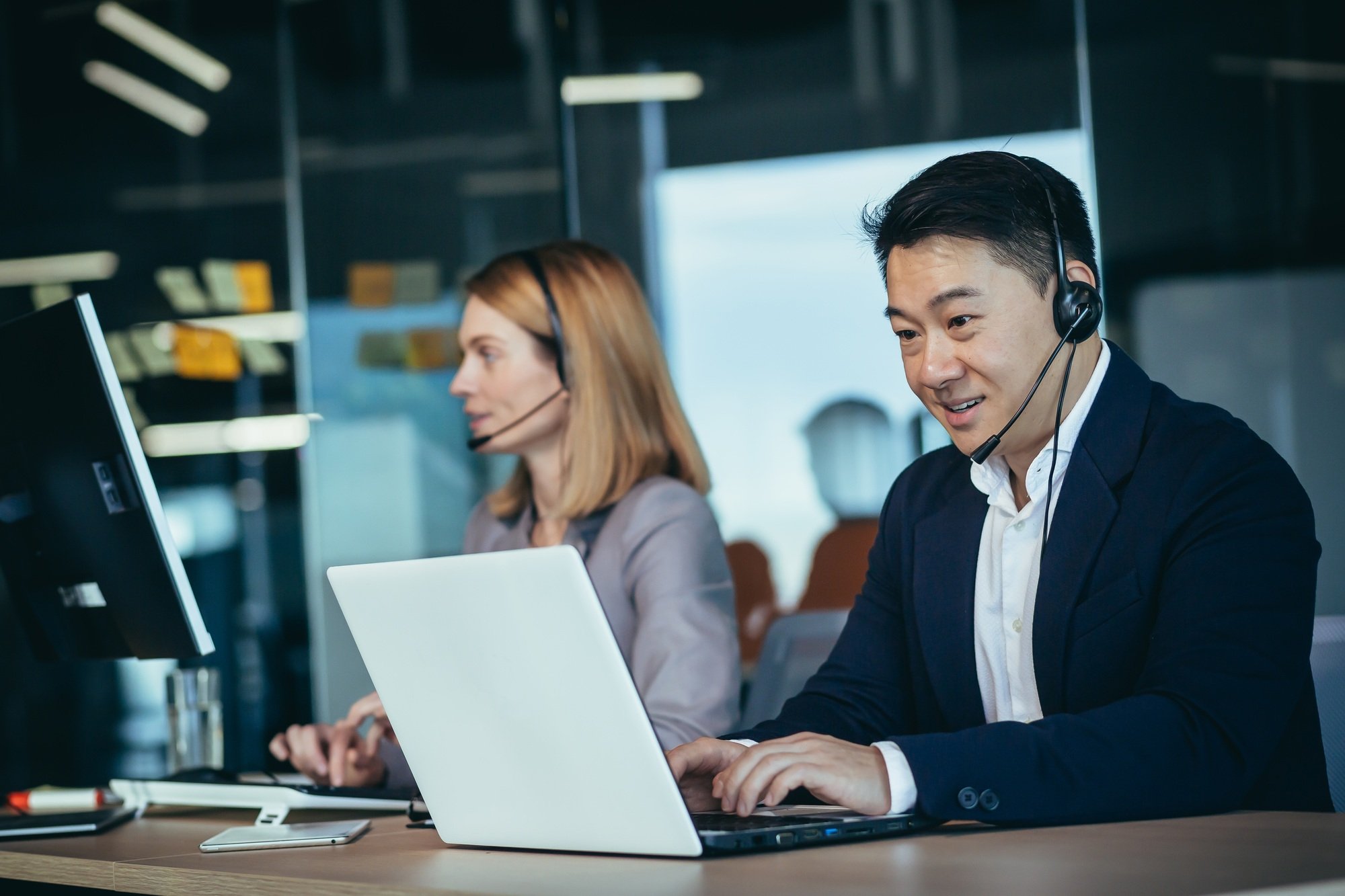 Happy call center employee communicates with customers, advises on video call