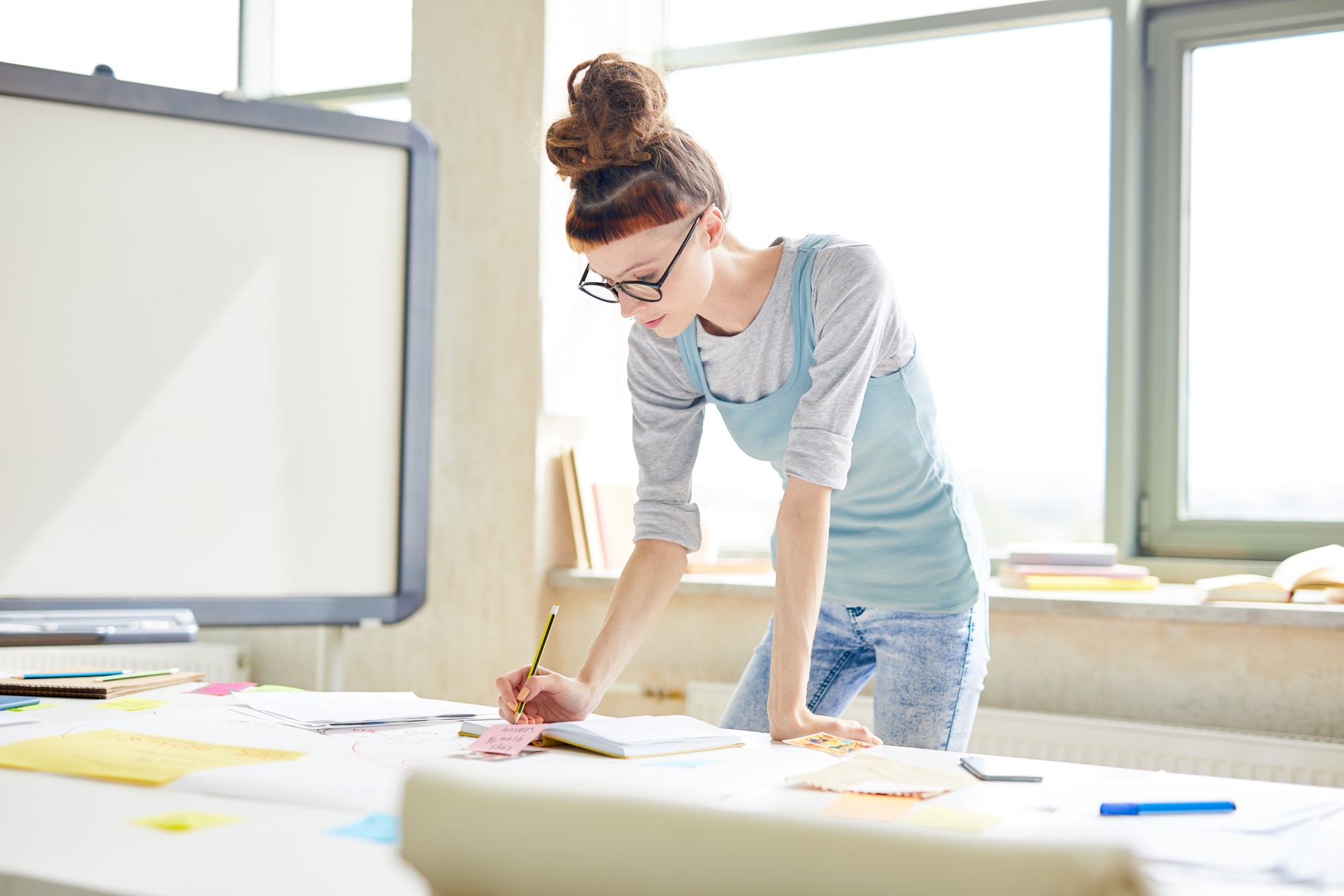 Hipster manager making notes in organizer