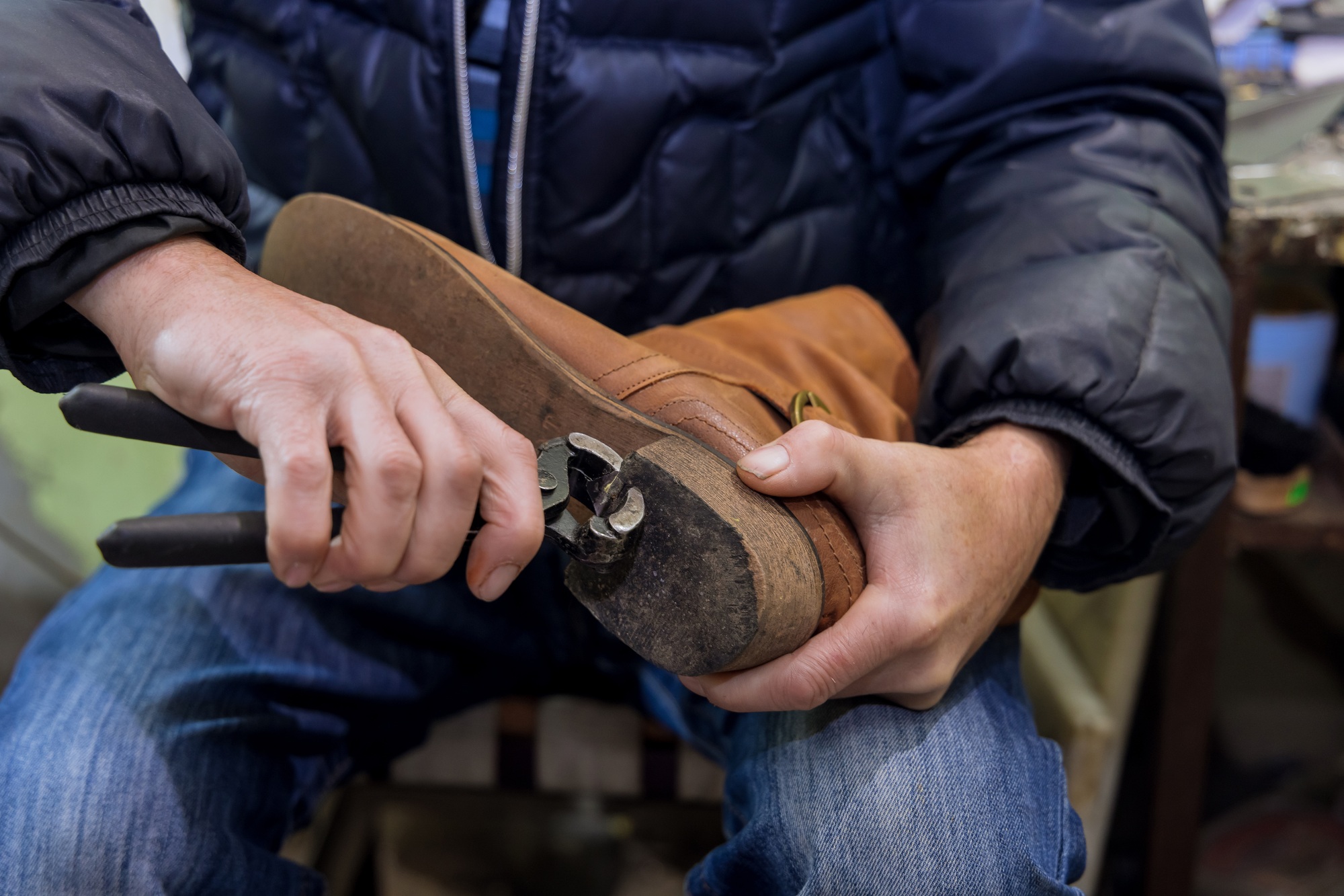 In the workshop of the master who specializes in shoe repairs, a pair of shoes is being taken care