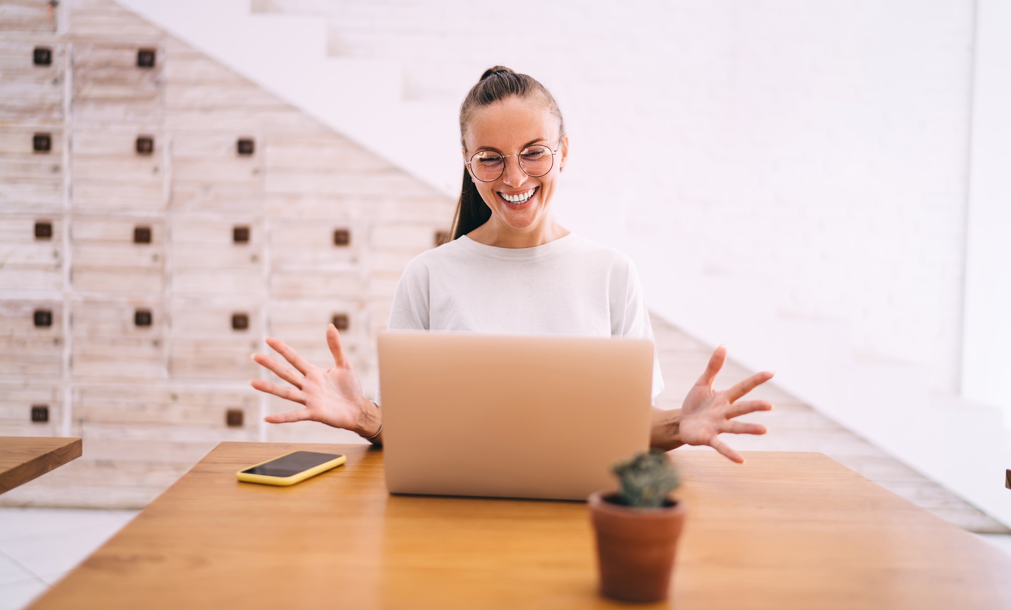 joyful woman with computer creating graphic design for website connecting to WIFI