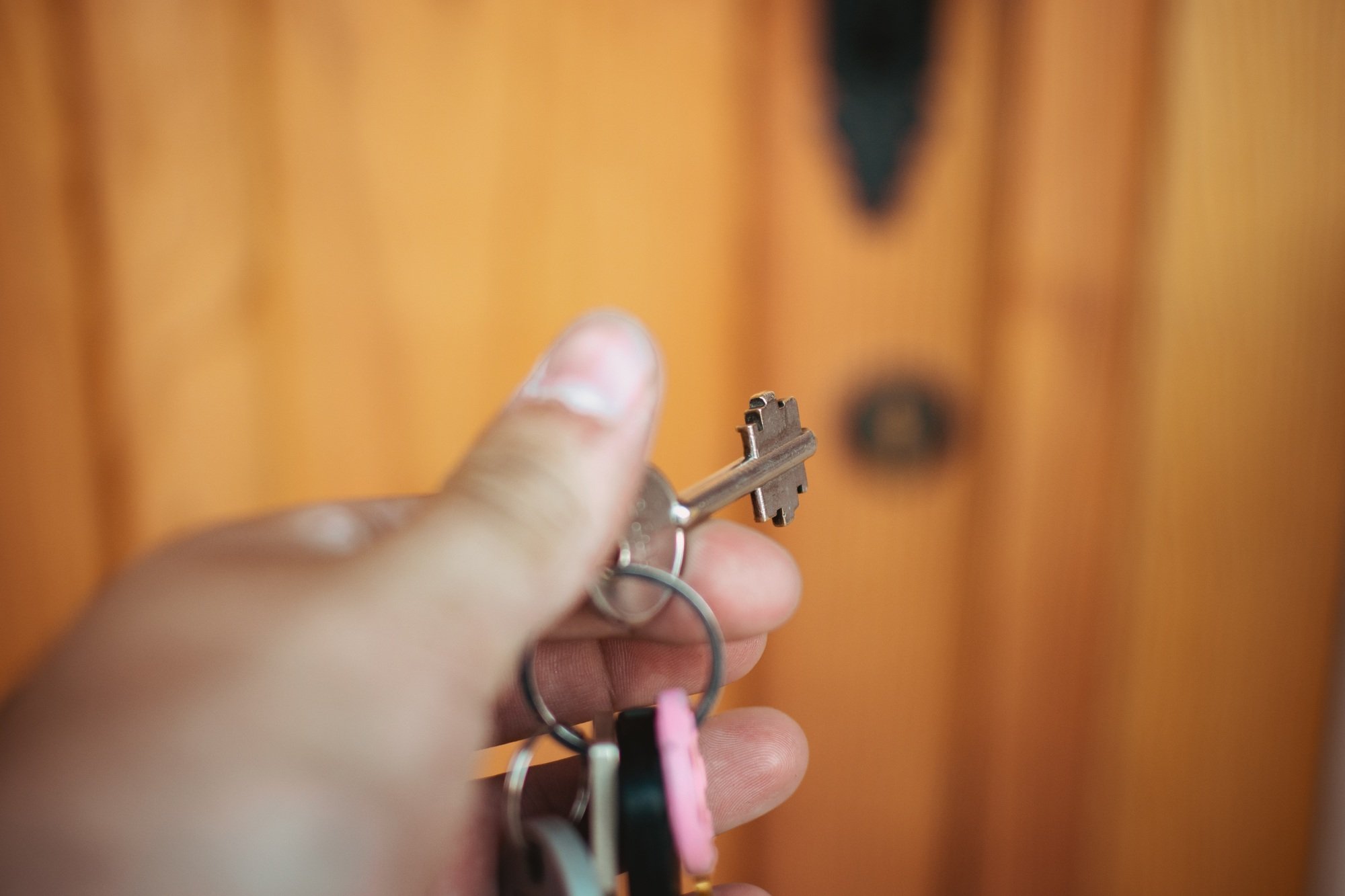 Key in the lock of a door opened by the owner of a vacation rental home.
