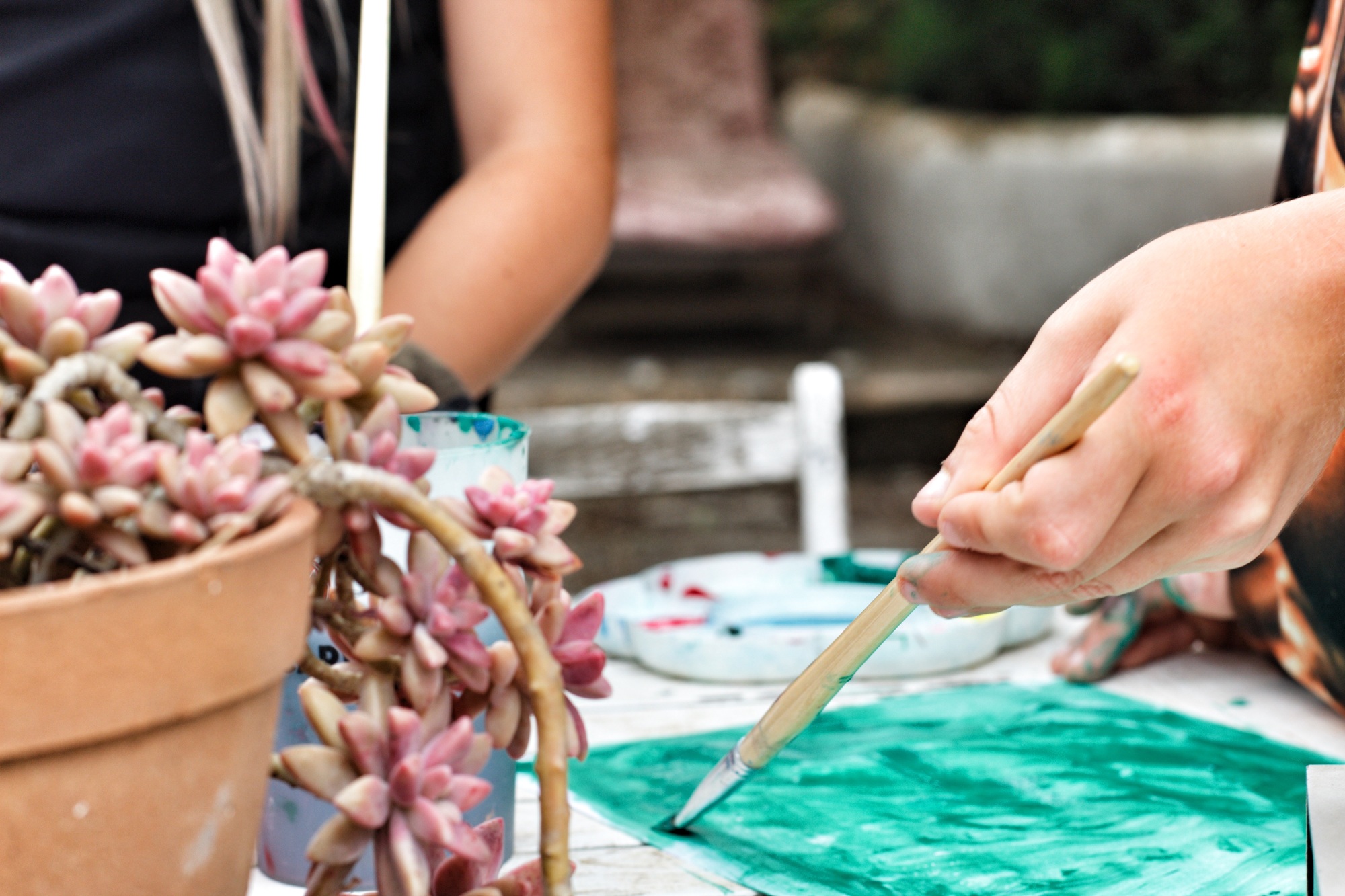 Kids painting and doing arts and crafts outdoors