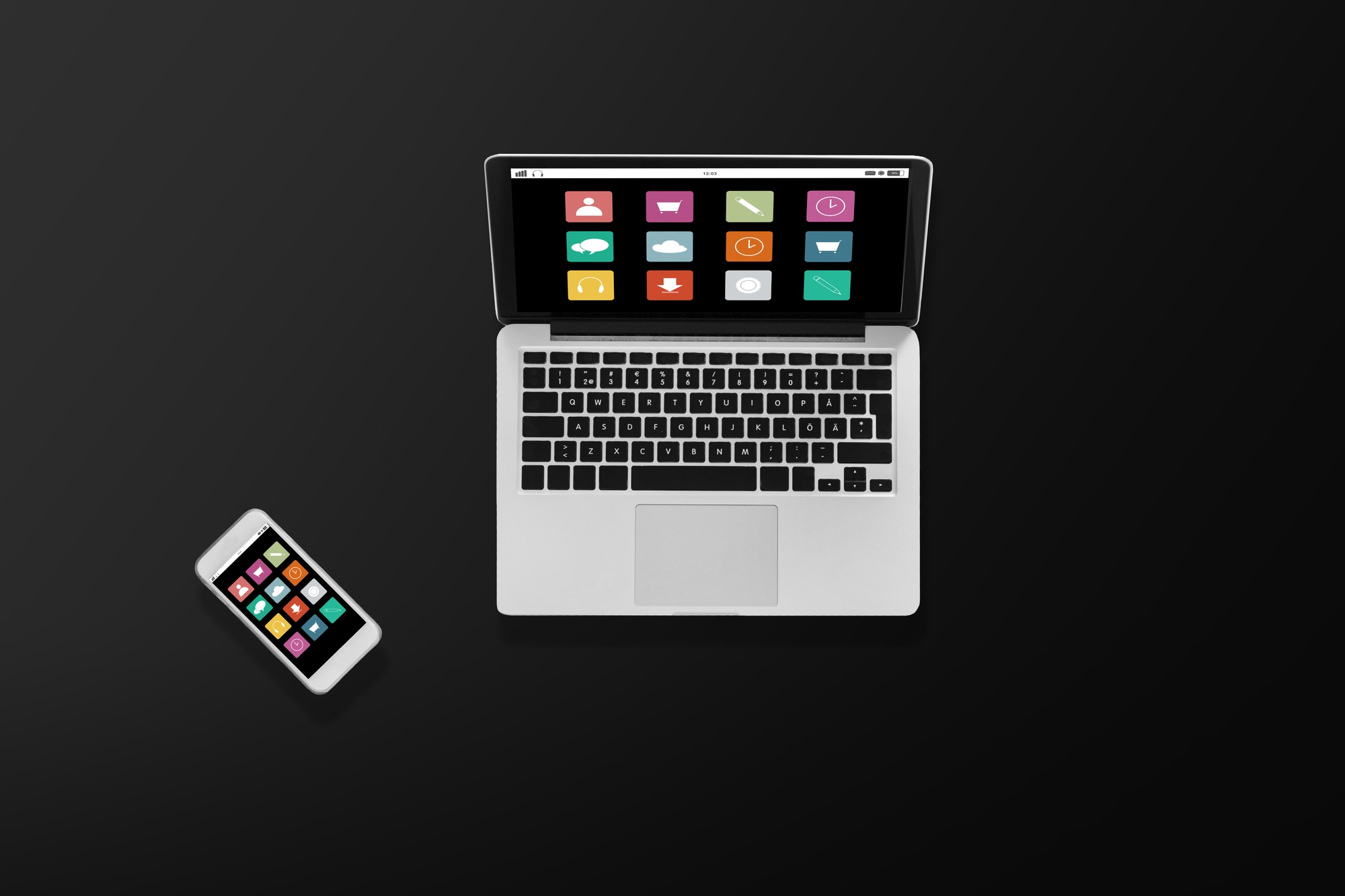 laptop computer with menu icons and smartphone