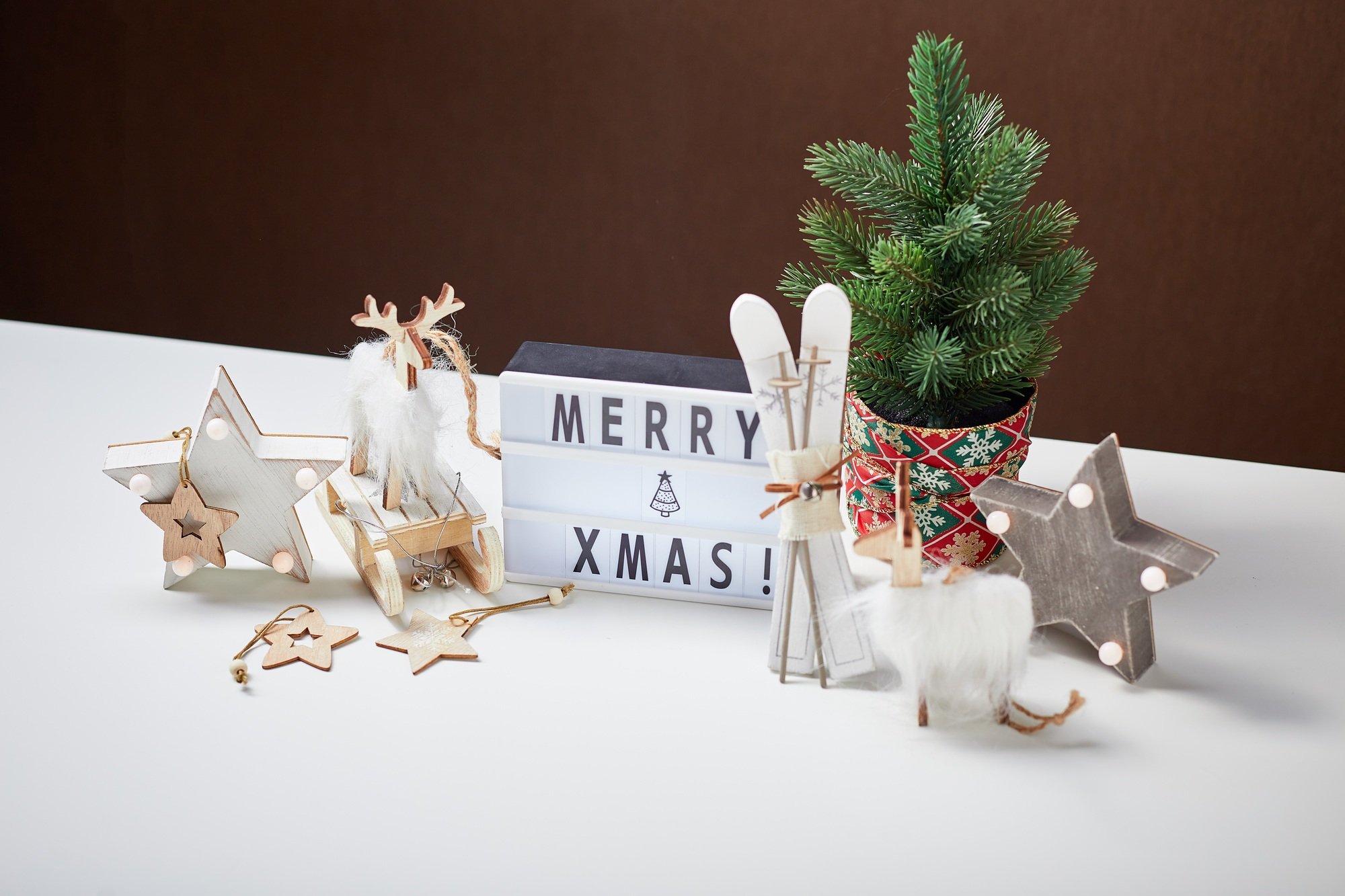Light box inscription Merry Xmas and wooden ornaments