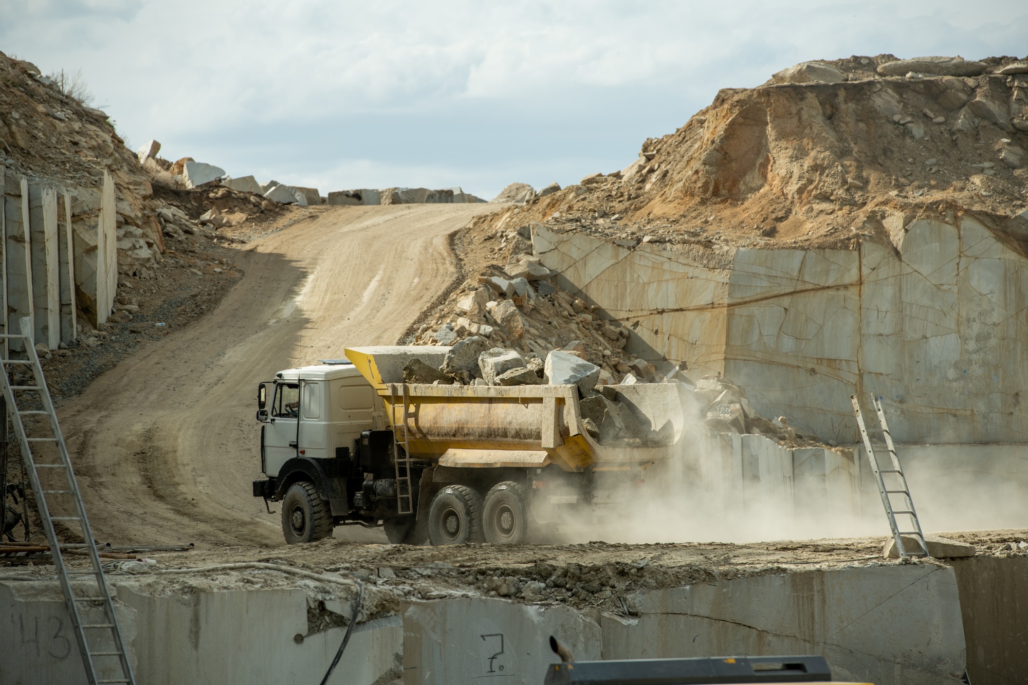 Lorry with huge stones or building materials moving along road