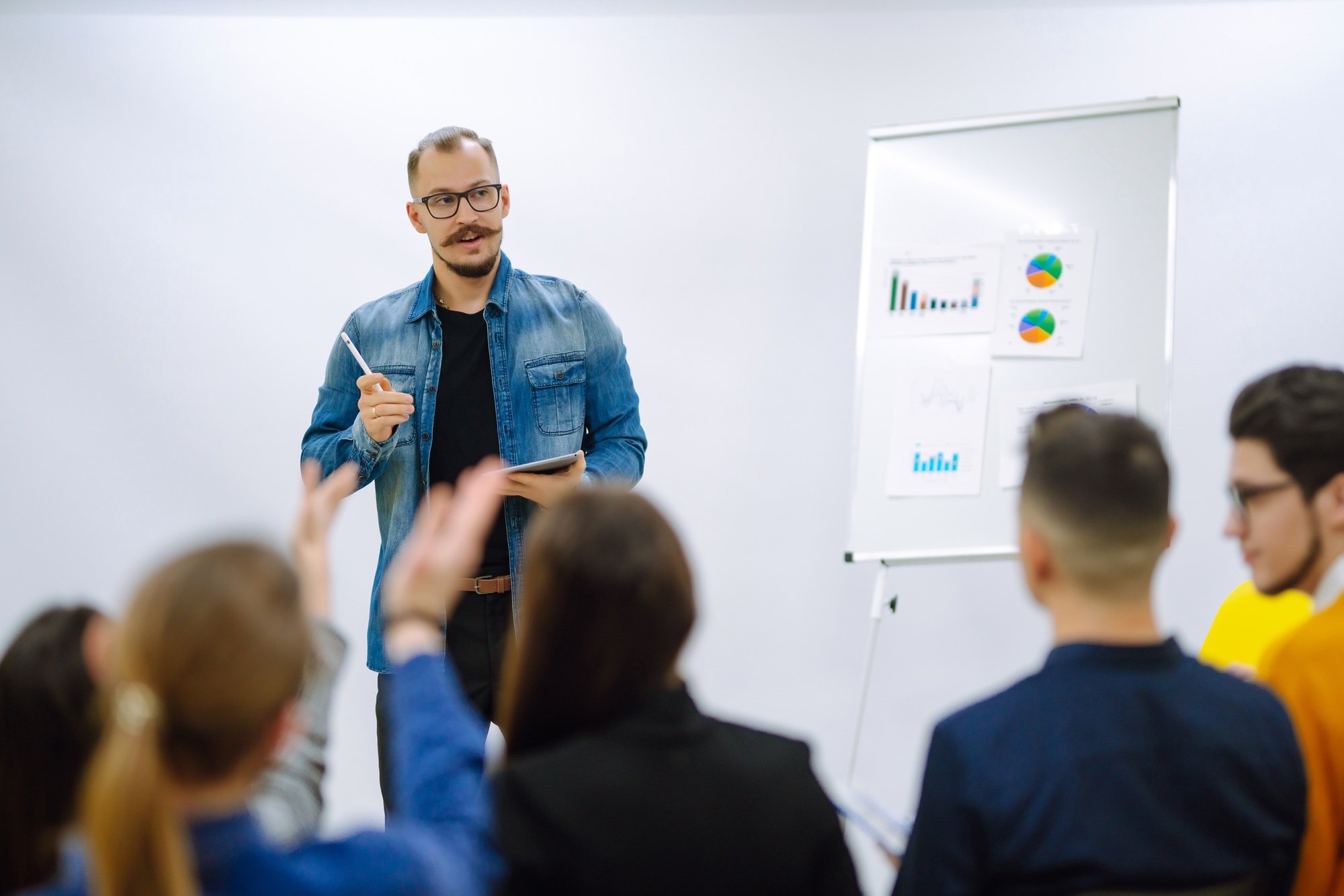 Male business coach speaker giving flipchart presentation
