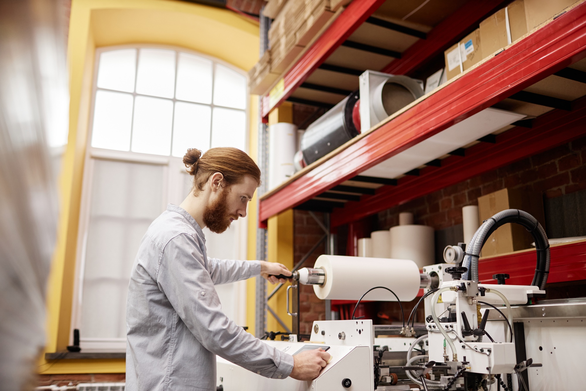 Man Working at Printing Factory Side View