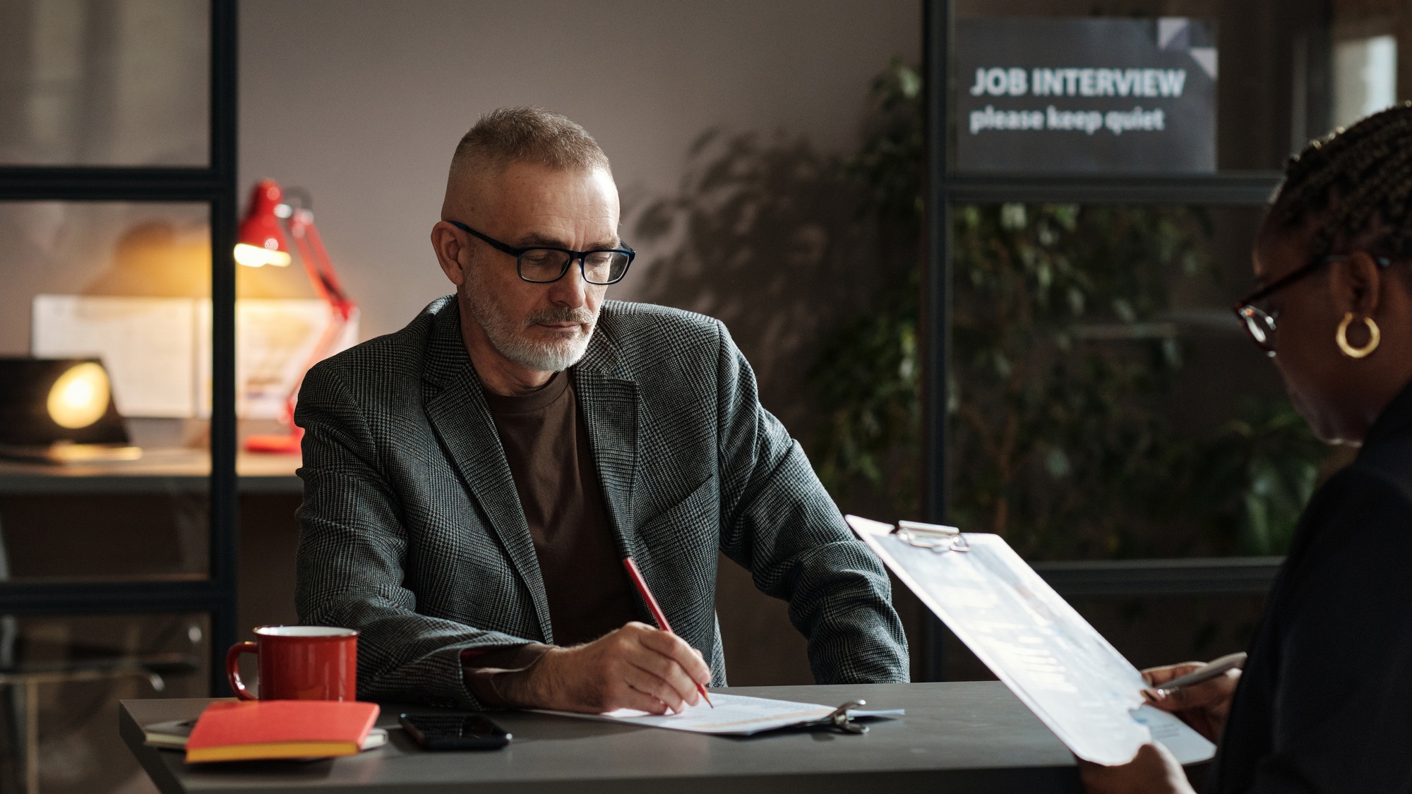 Manager examining resume of candidate
