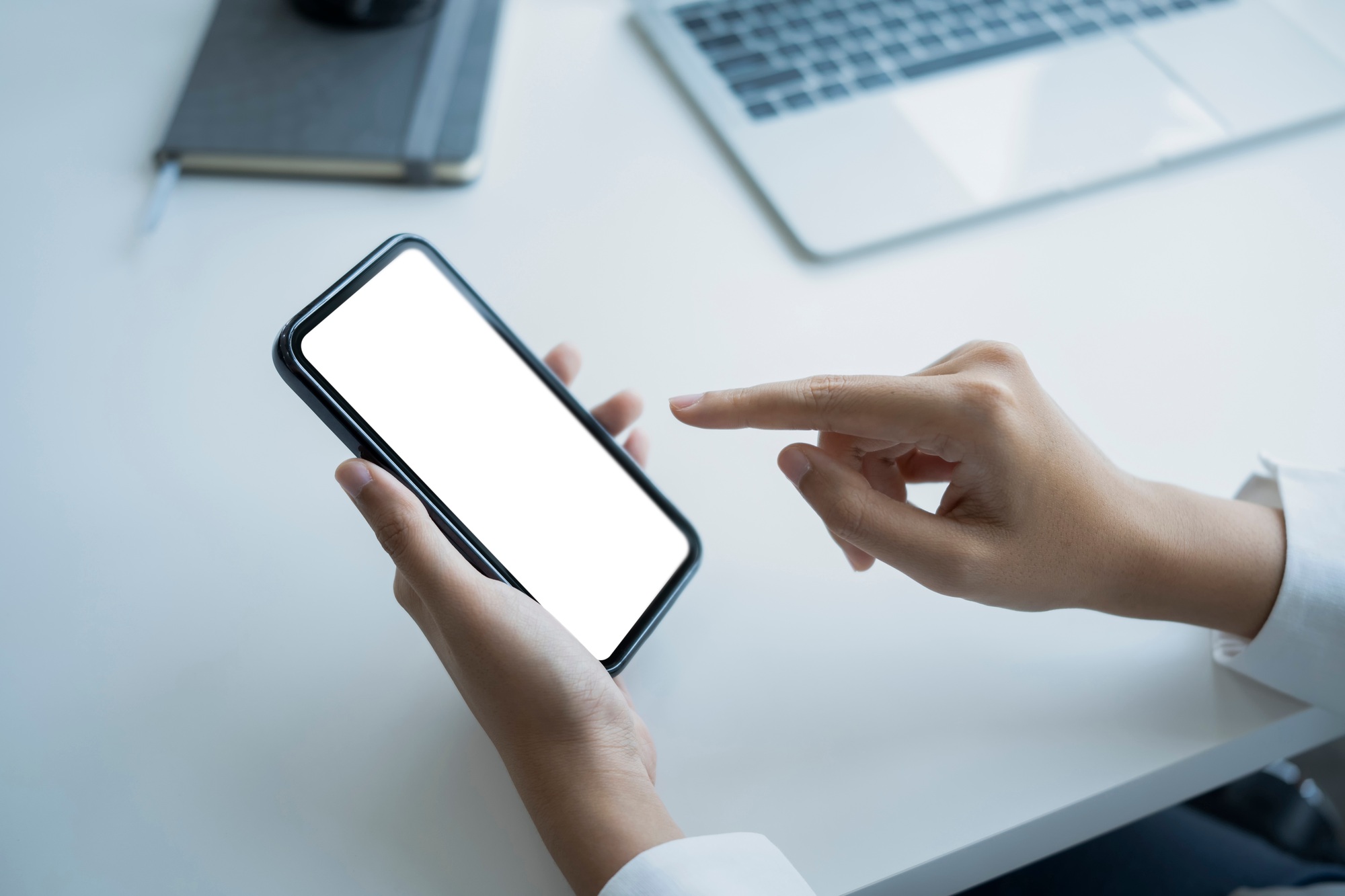 Mockup image of woman holding smart phone with white screen for advertising.