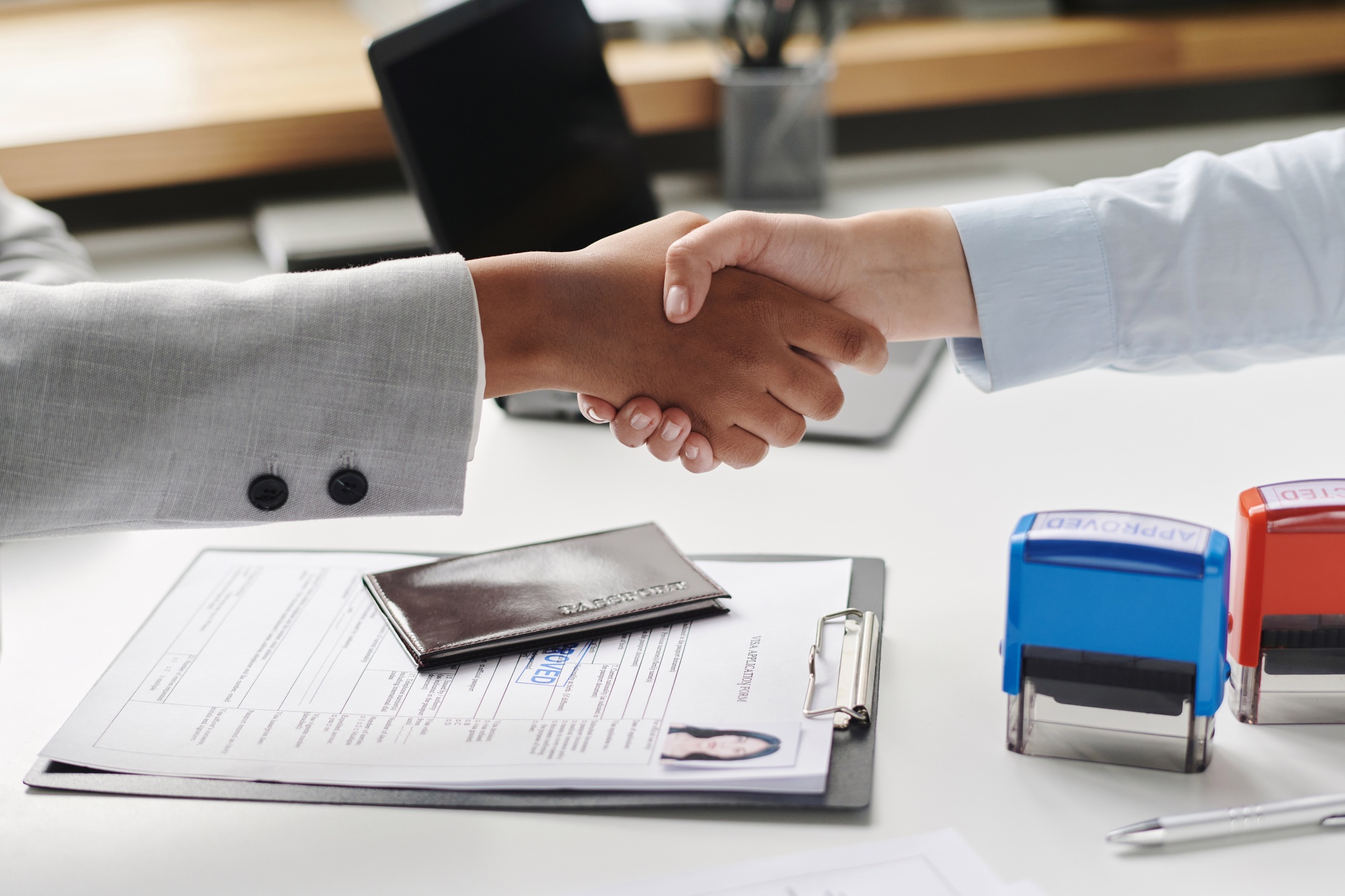 People shaking hands in visa agency