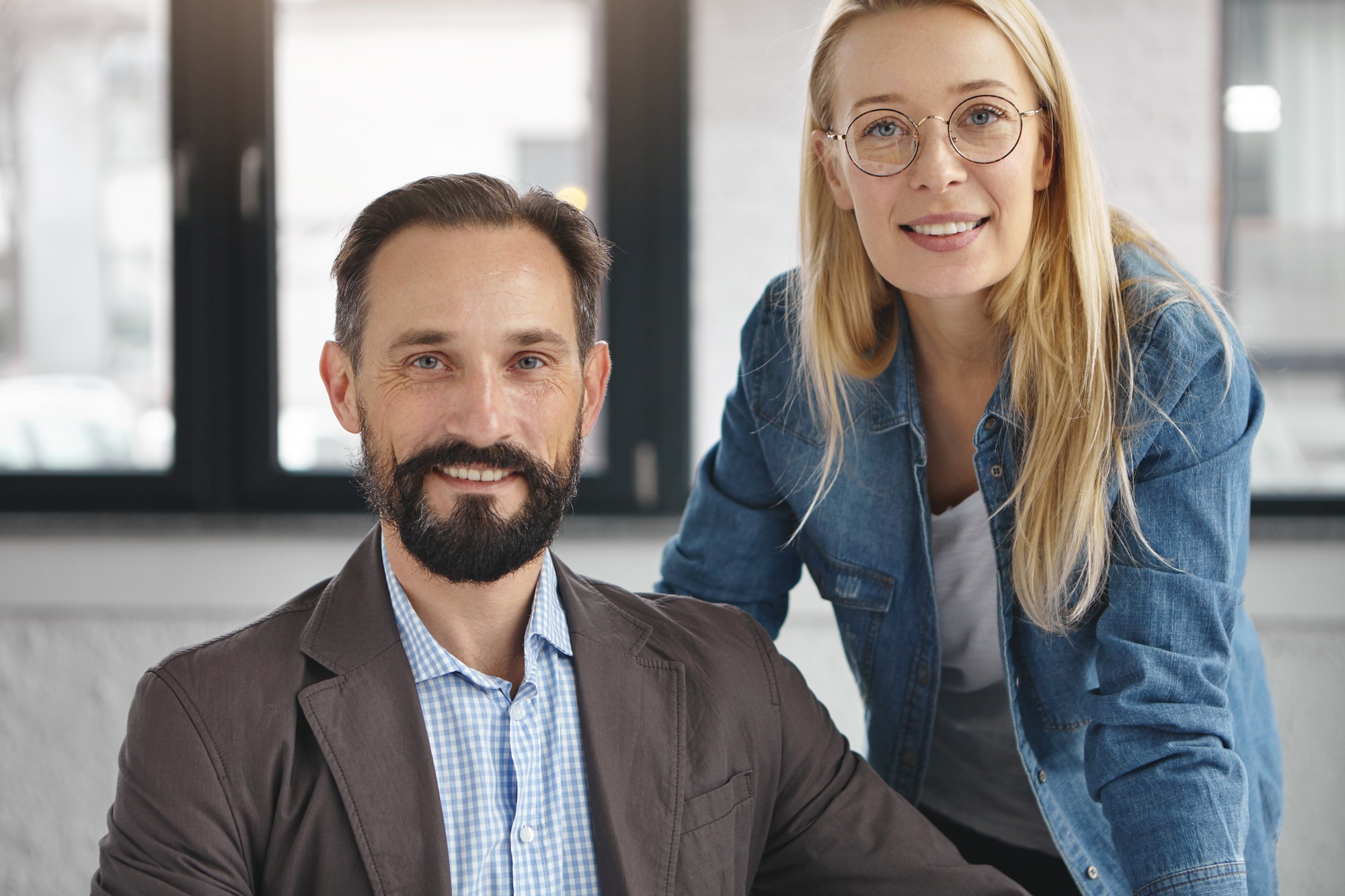 Photo of successful business partners or companions, study legal documents, have happy expressions a