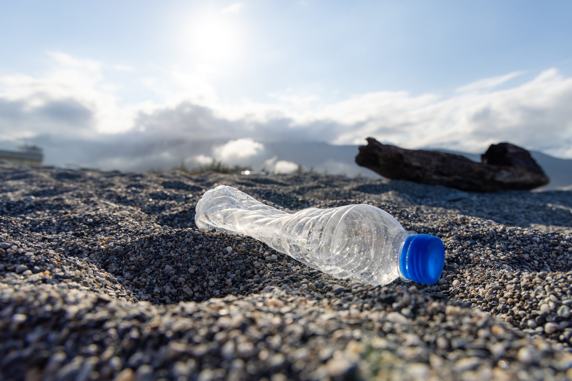Plastic bottle trash on the beach, pollution problem concept