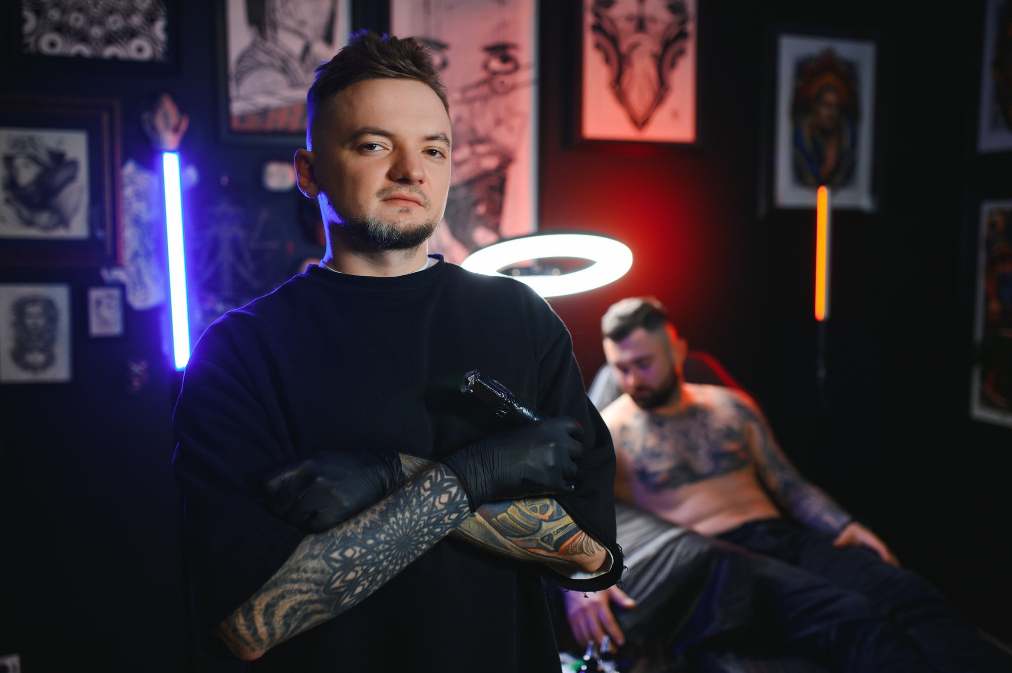 Portrait Of Tattoo Artist Standing Inside Parlor